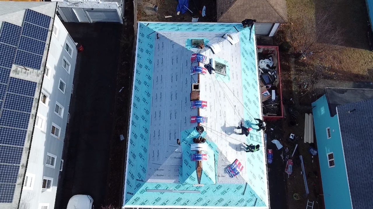 Roof Installation Roof Type: Hip Roof  Multi Family Home- 2 Story by Delarosa Construction & Design