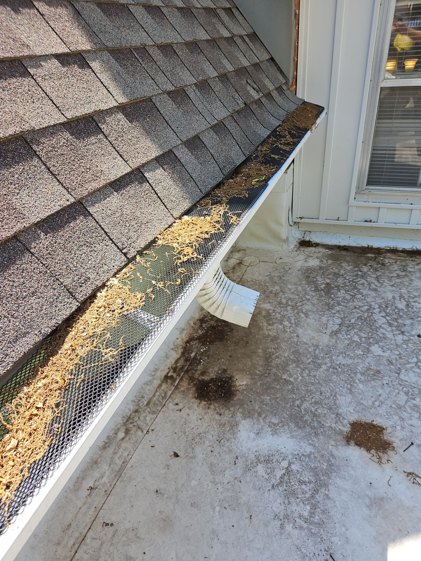 Commercial gutter cleaning Topeka, KS before photo with filled gutters