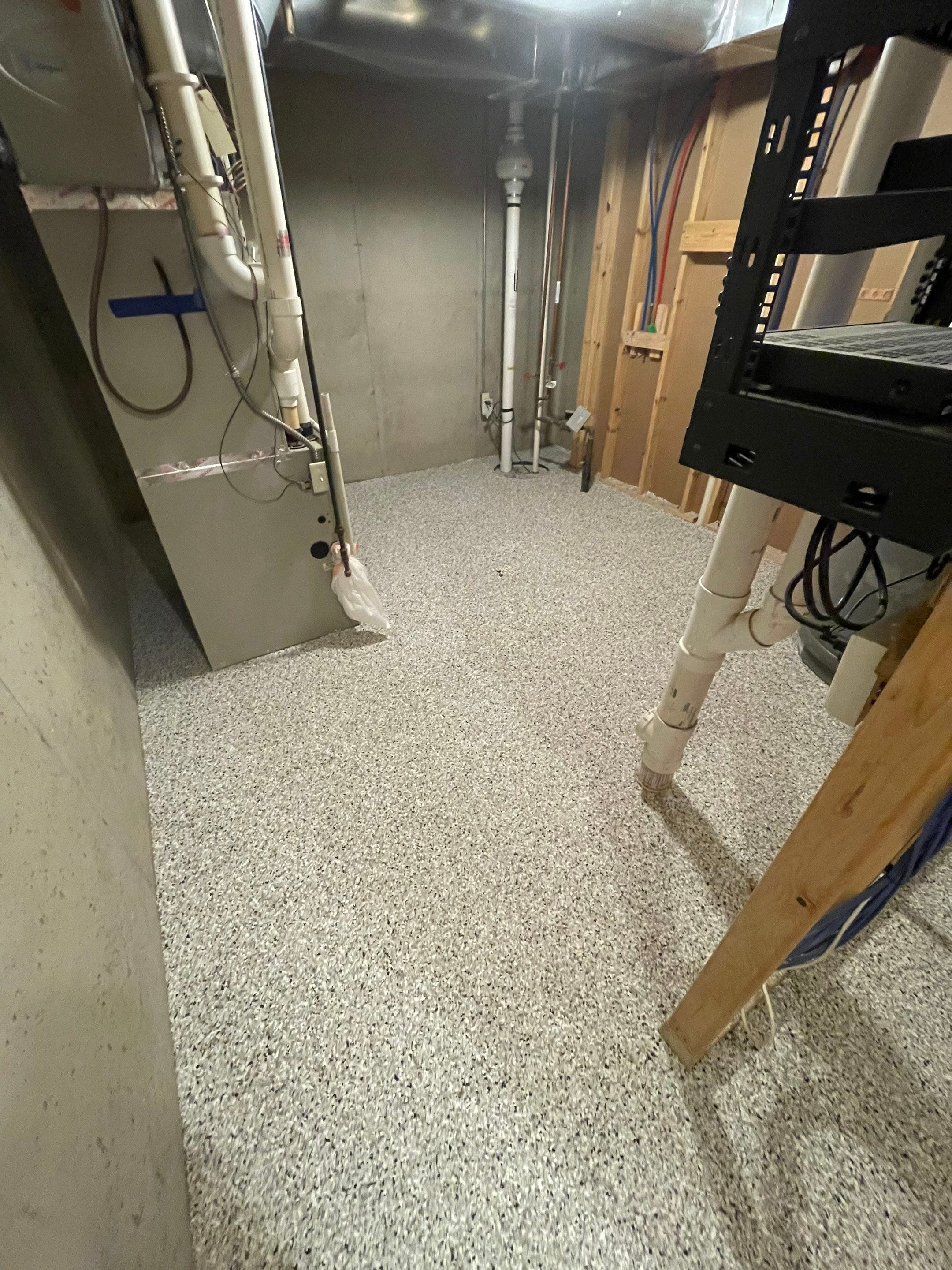 Sioux Falls Basement Floor Transformation with Durable Epoxy Flake Coating by Select Painting, Coatings & Garage Cabinets