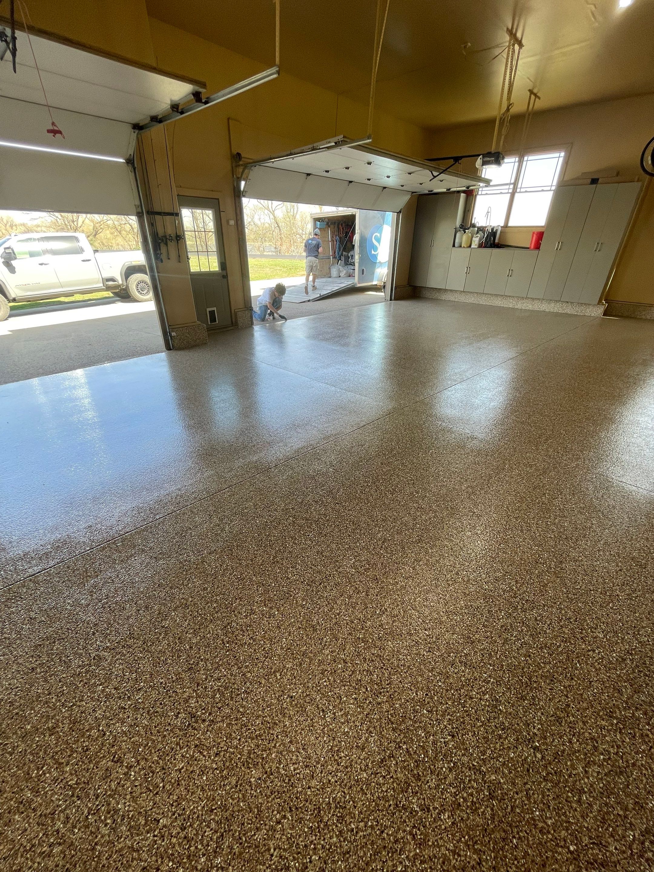 Residential Garage Floor Transformation with Speckled Epoxy Coating by Select Painting, Coatings & Garage Cabinets