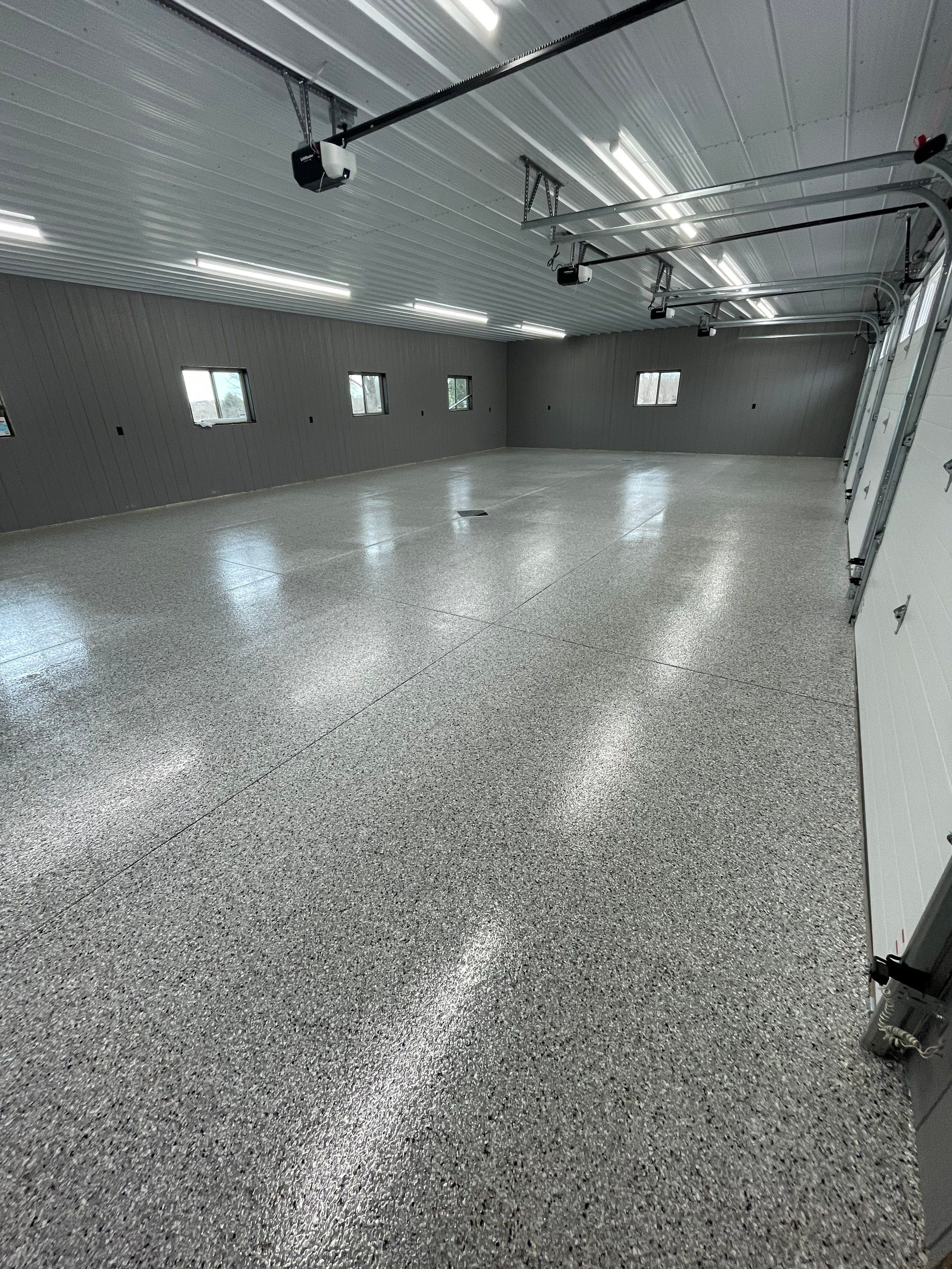 Speckled Epoxy Floor Coating for Large Shop in Rock Valley by Select Painting, Coatings & Garage Cabinets