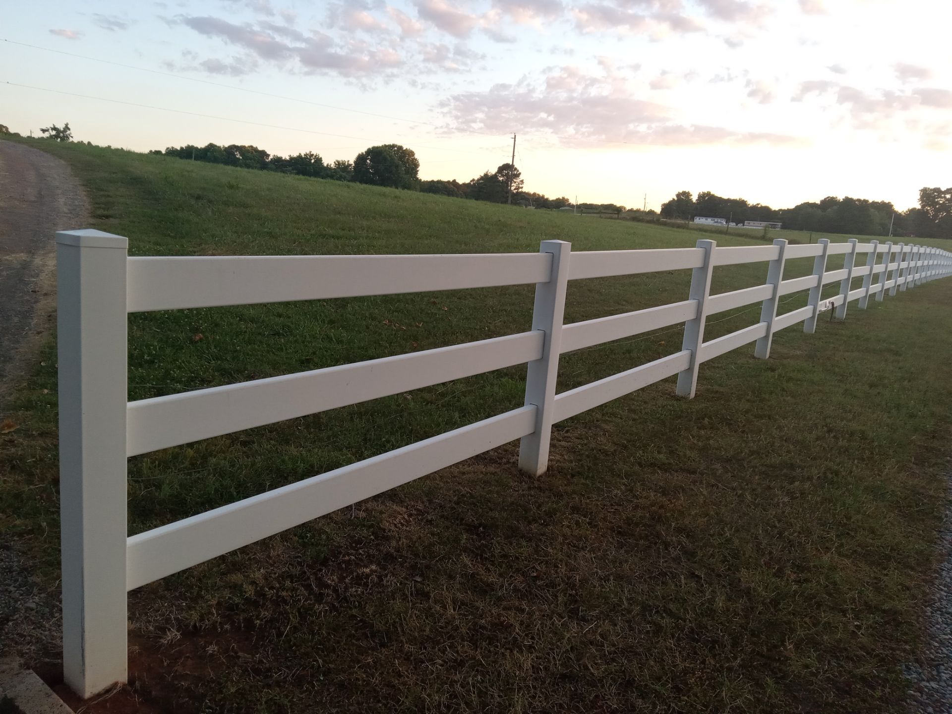 pressure washing white vinyl fence to remove dirt grime for clean appearance restoring it to like new condition