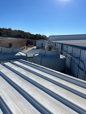 Wide view of a completed metal roof on commercial building