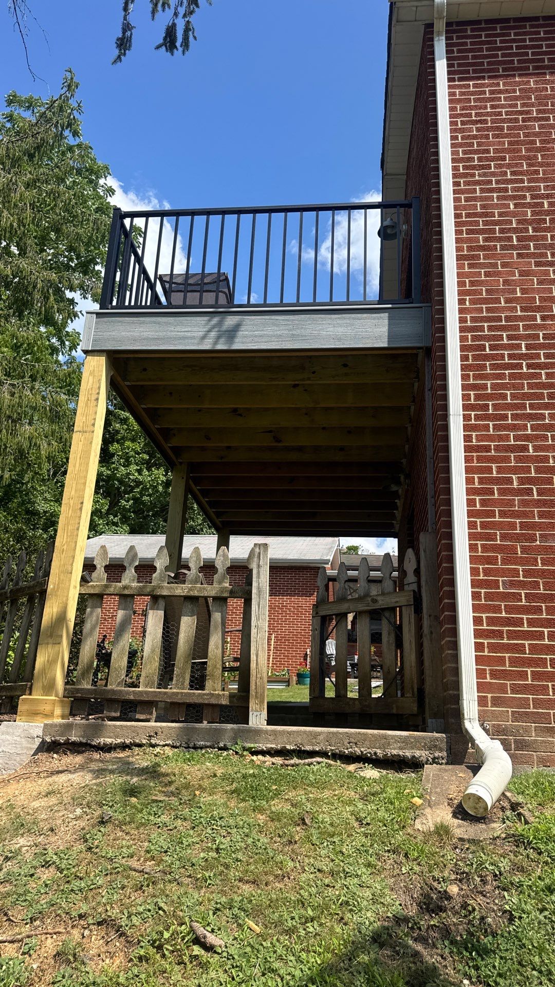 Elevated Composite Deck Rebuild with Black Metal Railing in Lewisburg by Walnut Hollow Decks & Outdoor Living