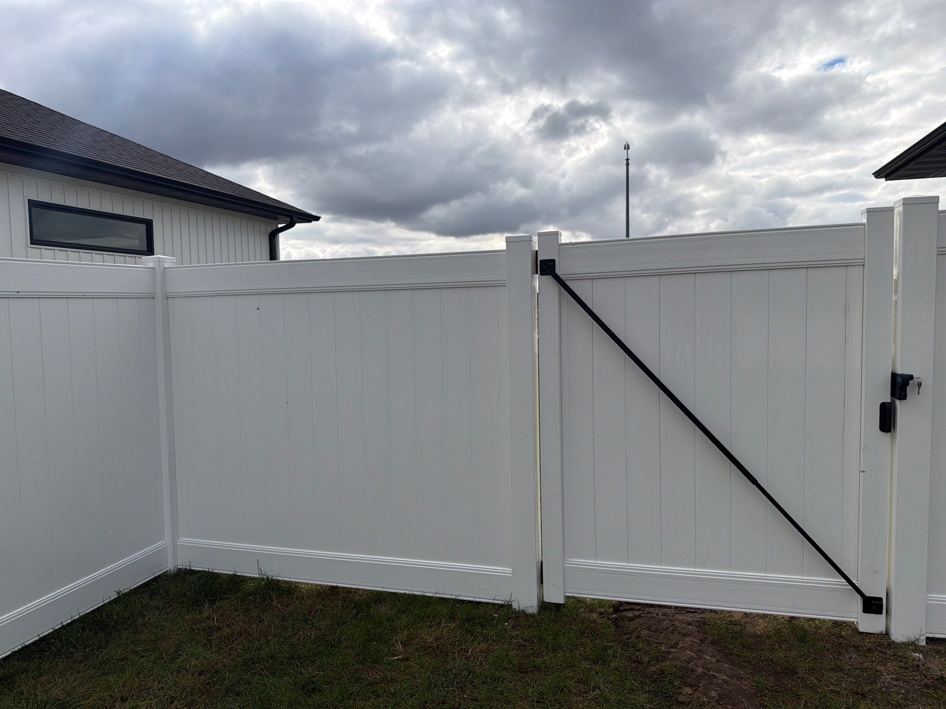 Residential White Vinyl Privacy Fence Installation in Janesville by Perfect Picket Fence and Stain