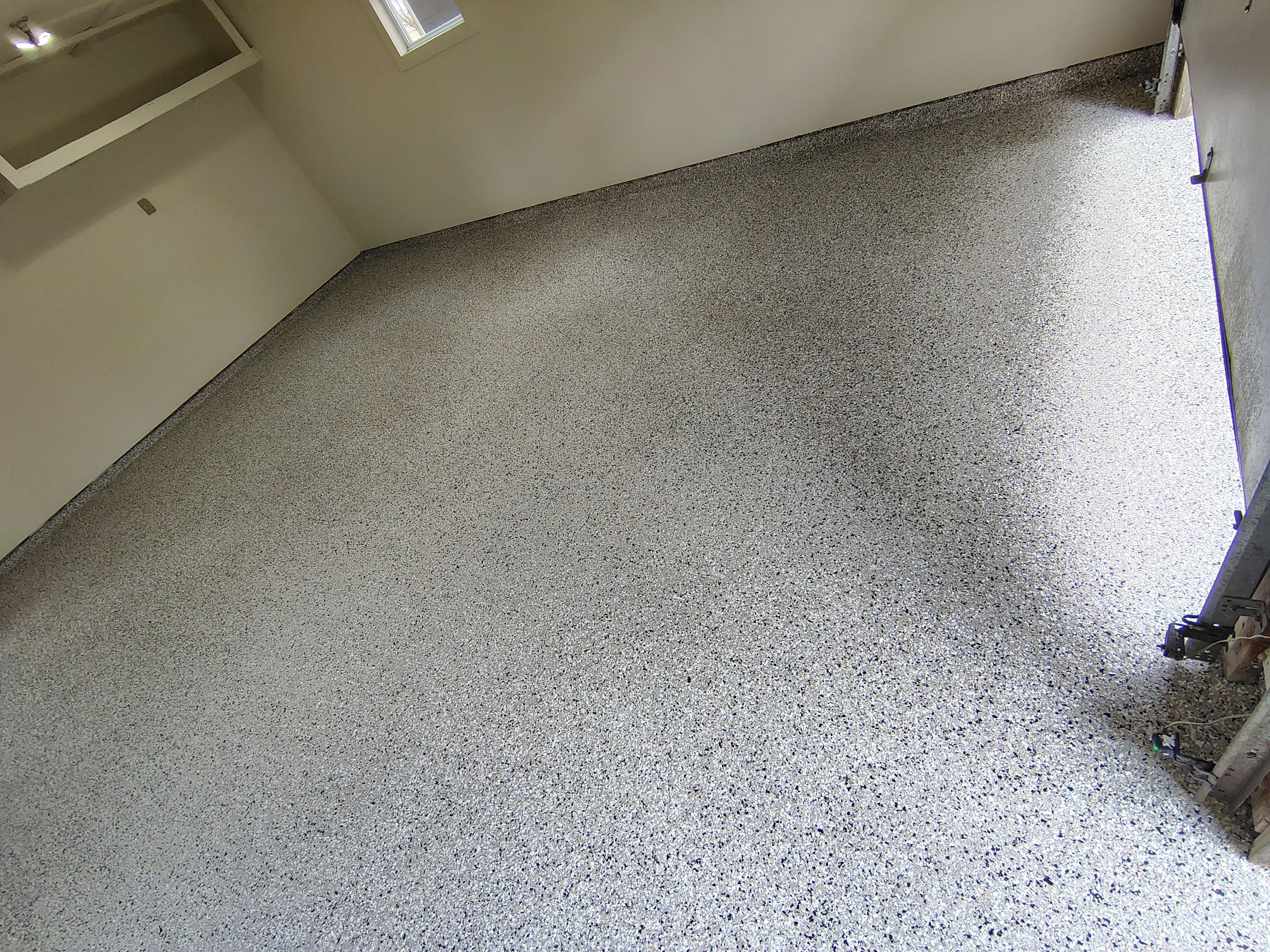 Full-Flake Epoxy Garage Floor Coating Installation in Sioux Falls by Select Painting, Coatings & Garage Cabinets