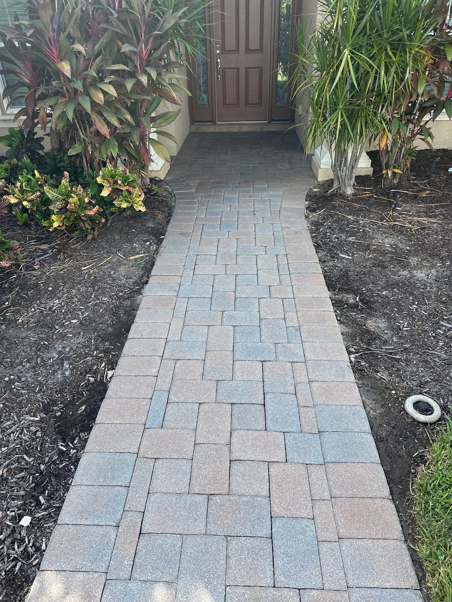 Paver Driveway, Entryway, Sidewalk, and Street Curbing Cleaning in Winding River Community, Bradenton, FL by Sunshine AquaWash
