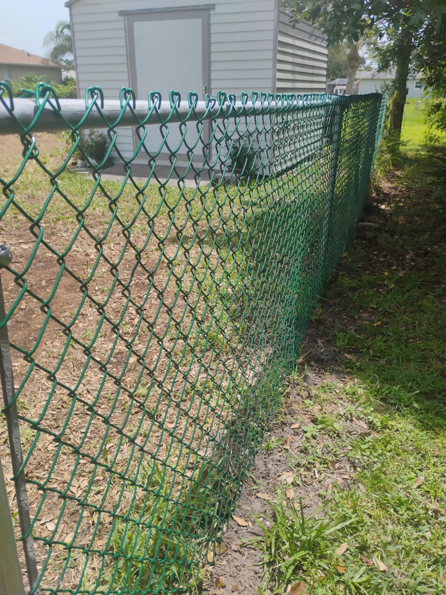 Green Vinyl-Coated Chain Link Fence Installation in North Port by True Fence LLC