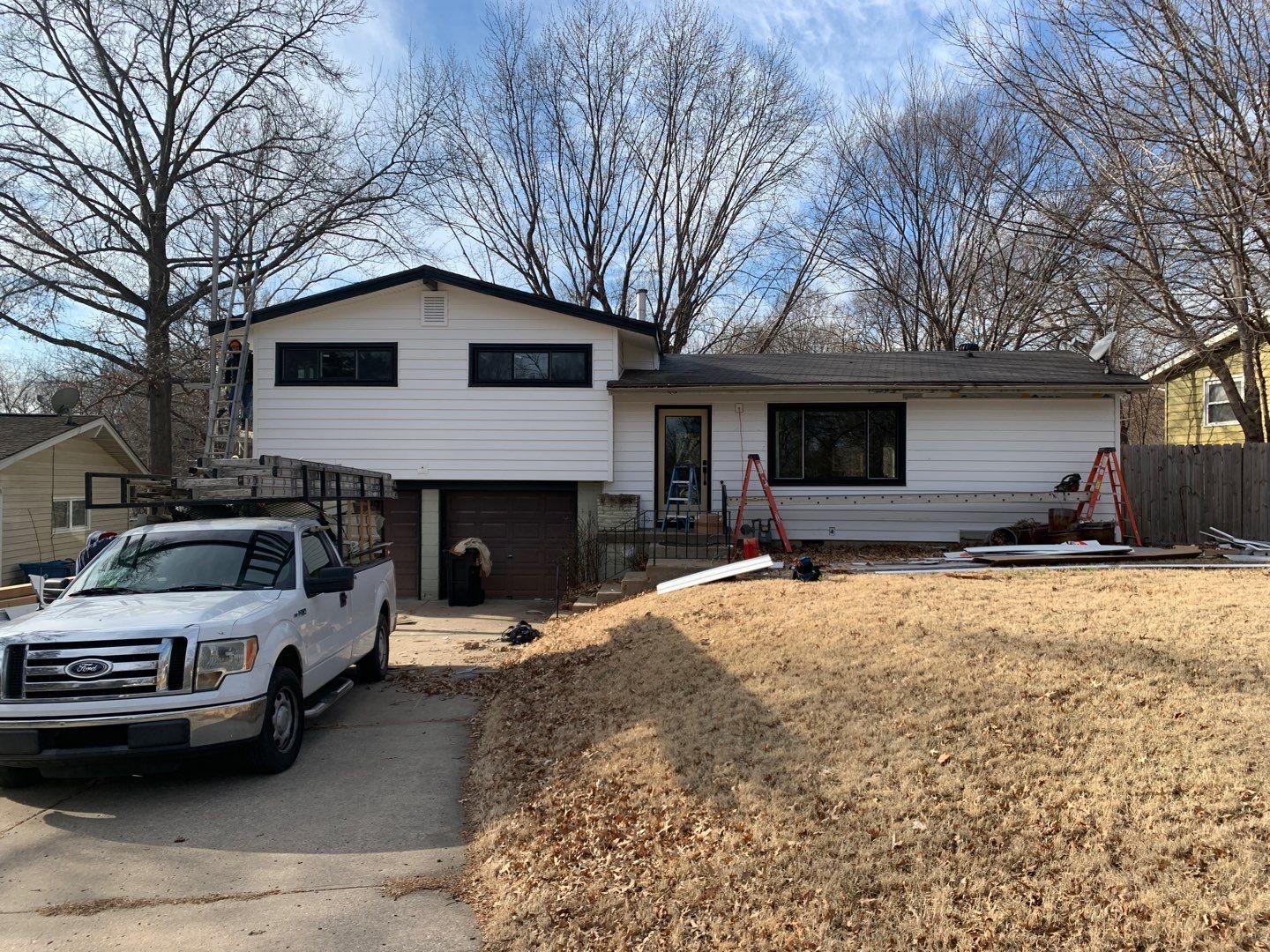 White Craneboard Siding and Heartland Window Installation in Parkville by EEC Windows, Siding & Roofing
