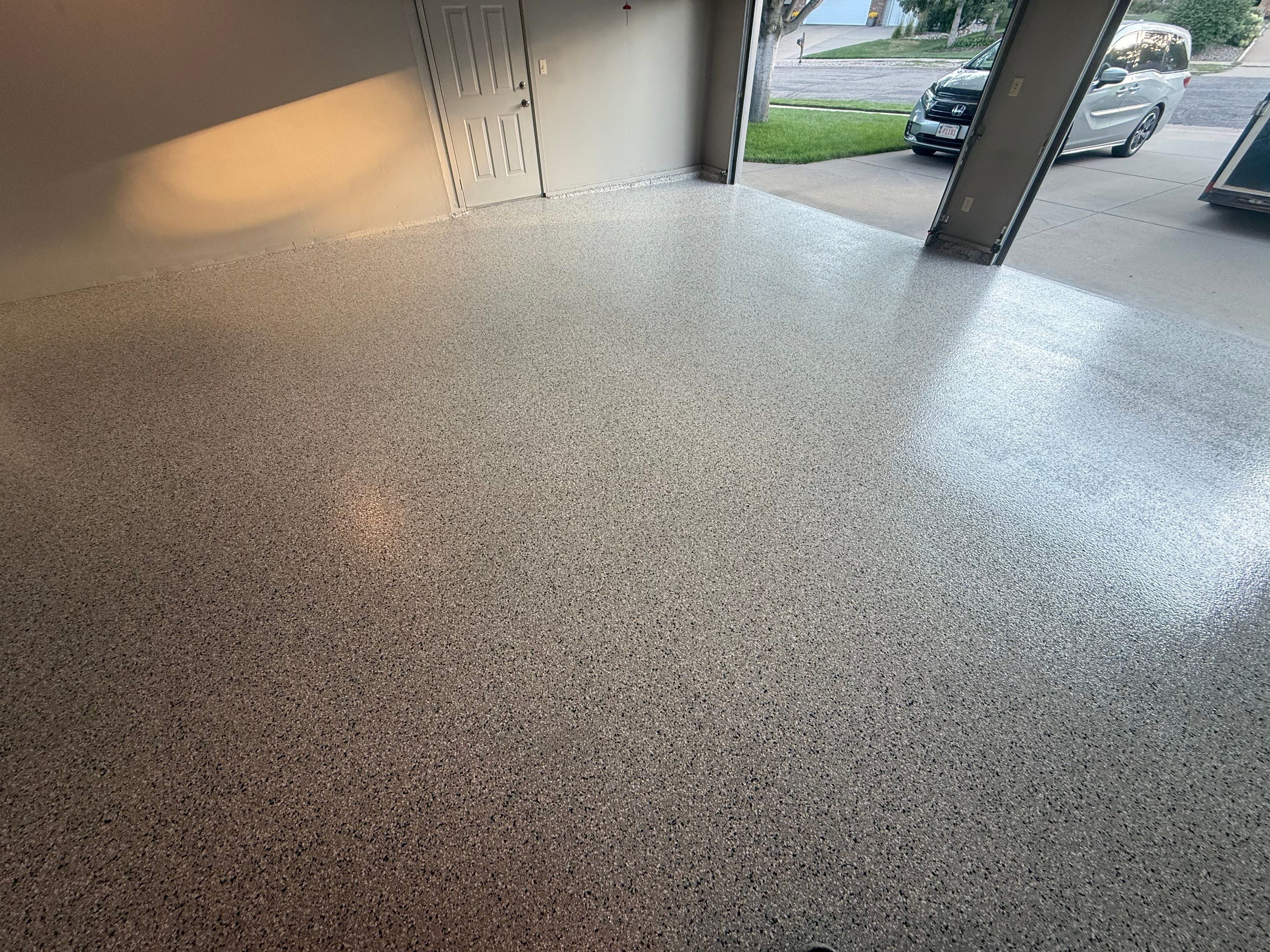 Cabin Fever Concrete Coating for Sioux Falls Garage by Select Painting, Coatings & Garage Cabinets