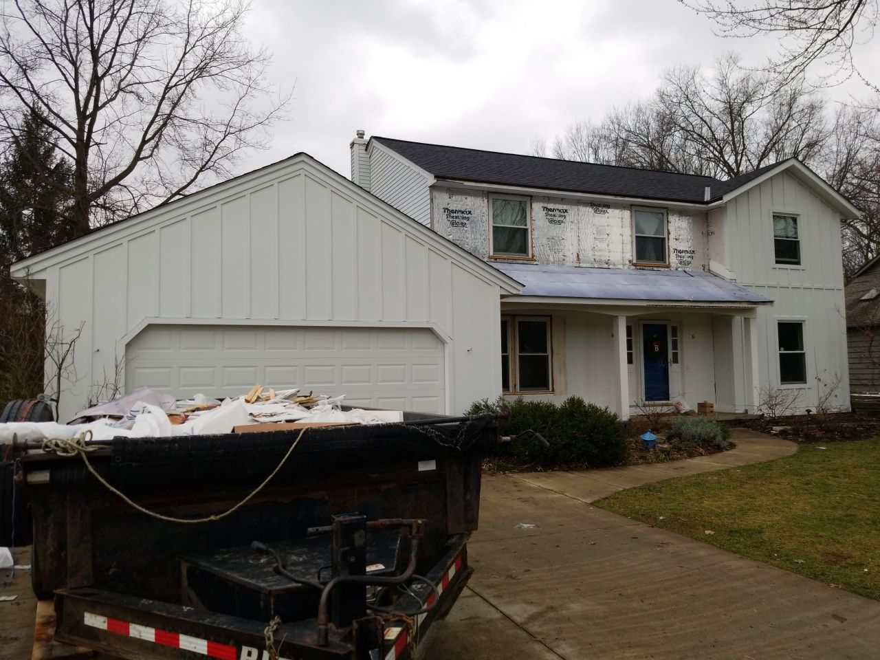 James Hardie Siding  using James Hardie Board and Batten, White by Absolute Roofing and Construction