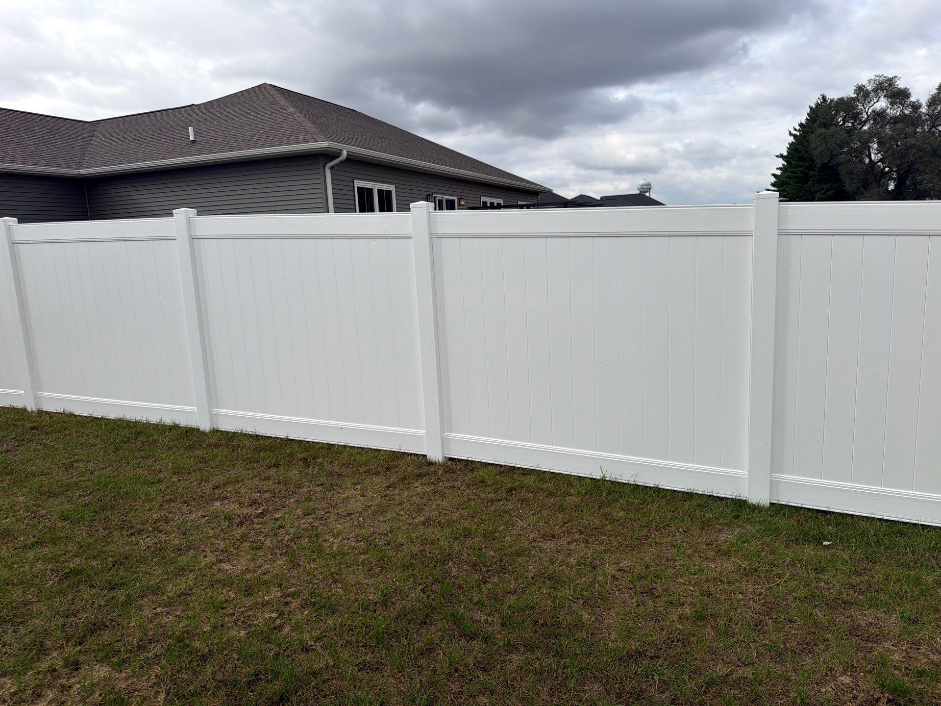 Residential White Vinyl Privacy Fence Installation in Janesville by Perfect Picket Fence and Stain