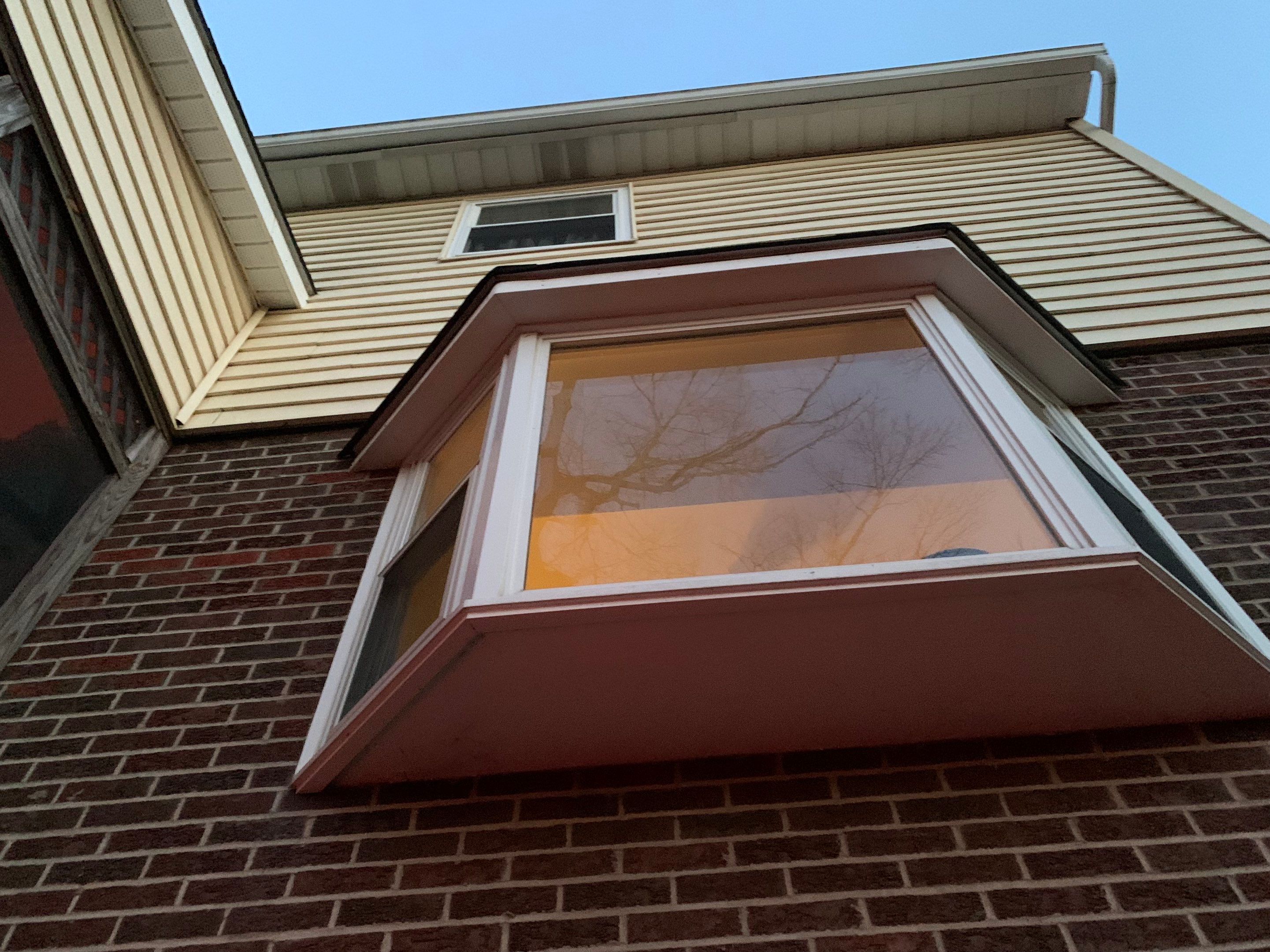 Replace dated vinyl siding with new white exterior Portfolio vinyl siding  by Secure Construction Company Inc