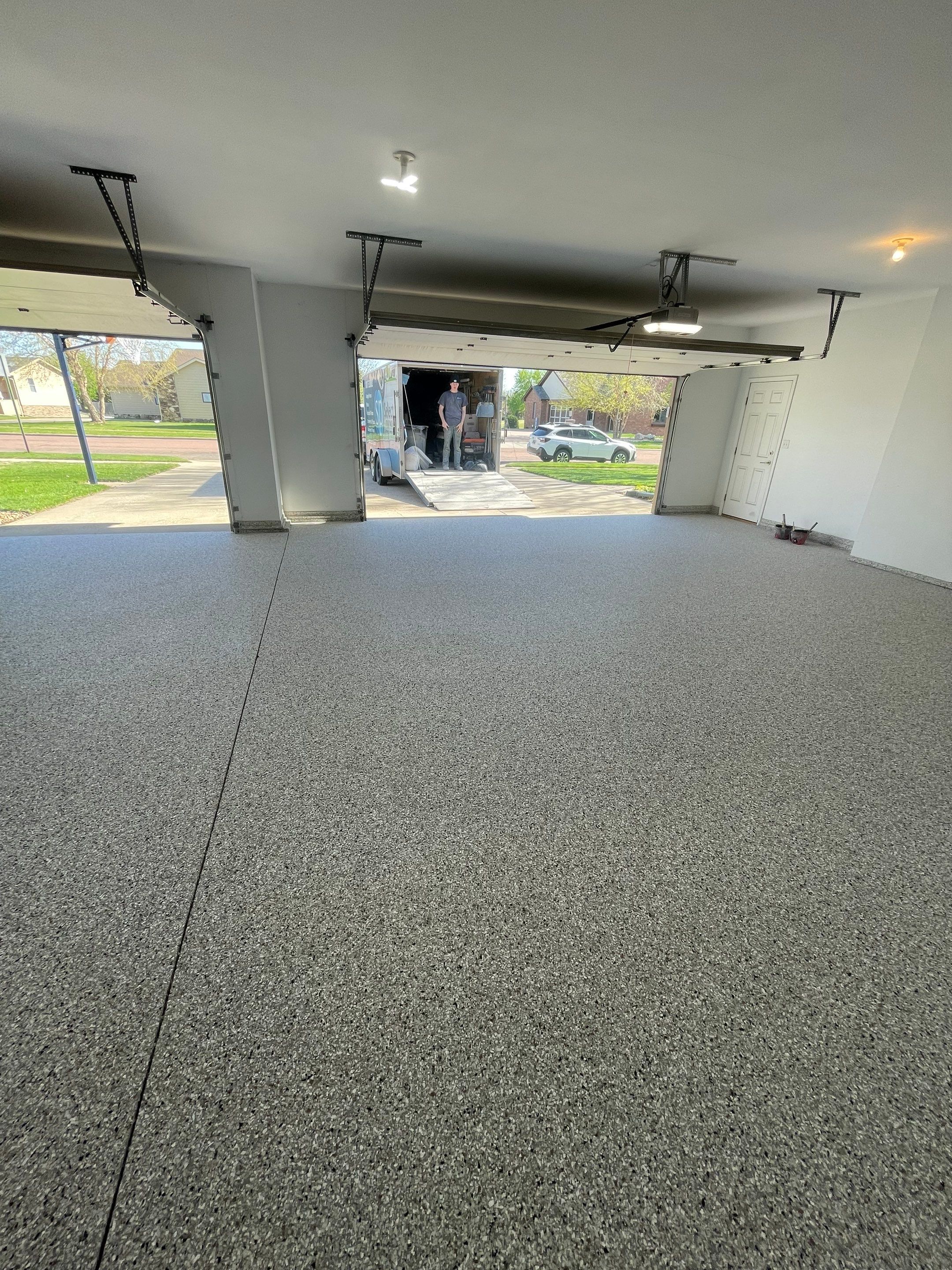 Yankton Garage Floor Restoration with Gray Speckled Epoxy Coating by Select Painting, Coatings & Garage Cabinets