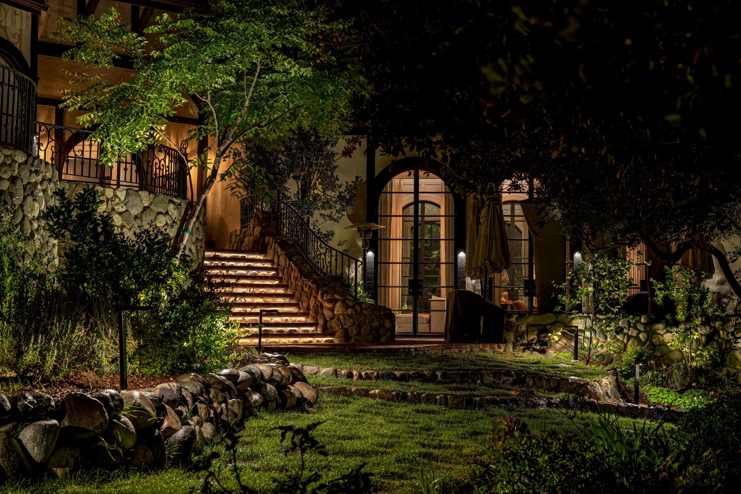 Tudor Estate Landscape Lighting with Integrated Stone Step Illumination by Outdoor Lights + Shades