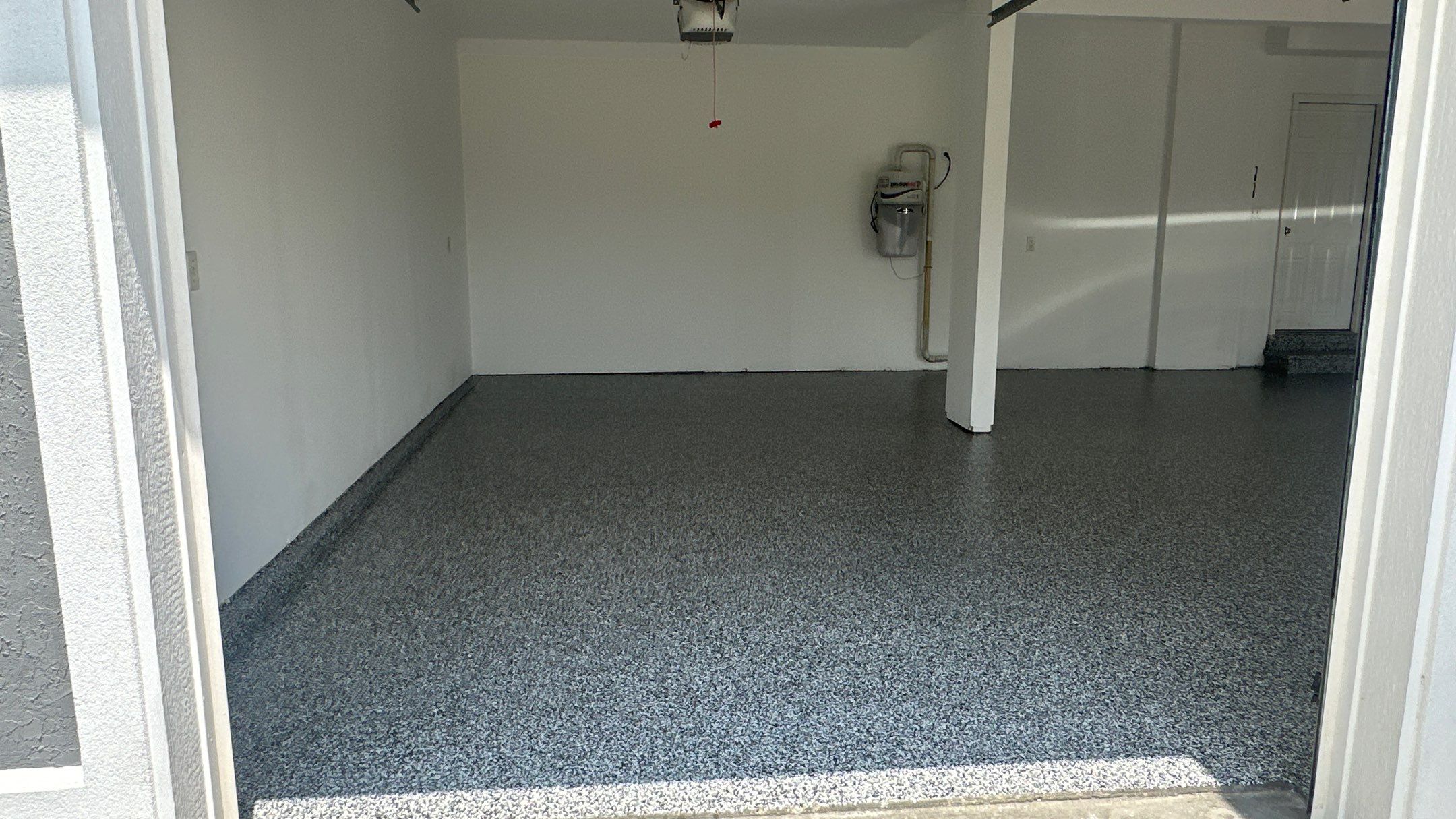Laura B. garage transformation with a new floor and garage storage  by Banner Garage
