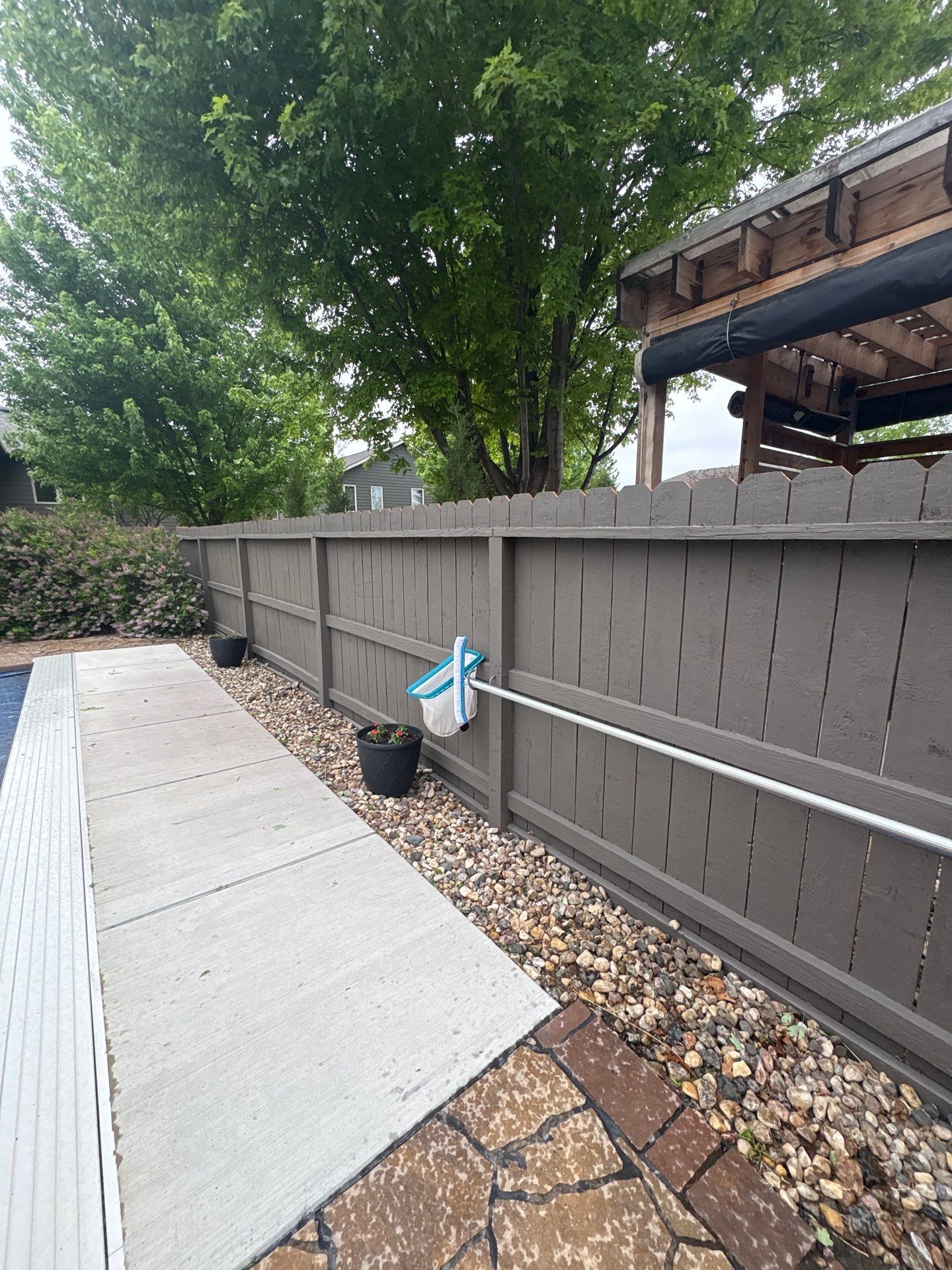 Sioux Falls Residential Exterior Update and Flagstone Pool Deck by Select Painting, Coatings & Garage Cabinets