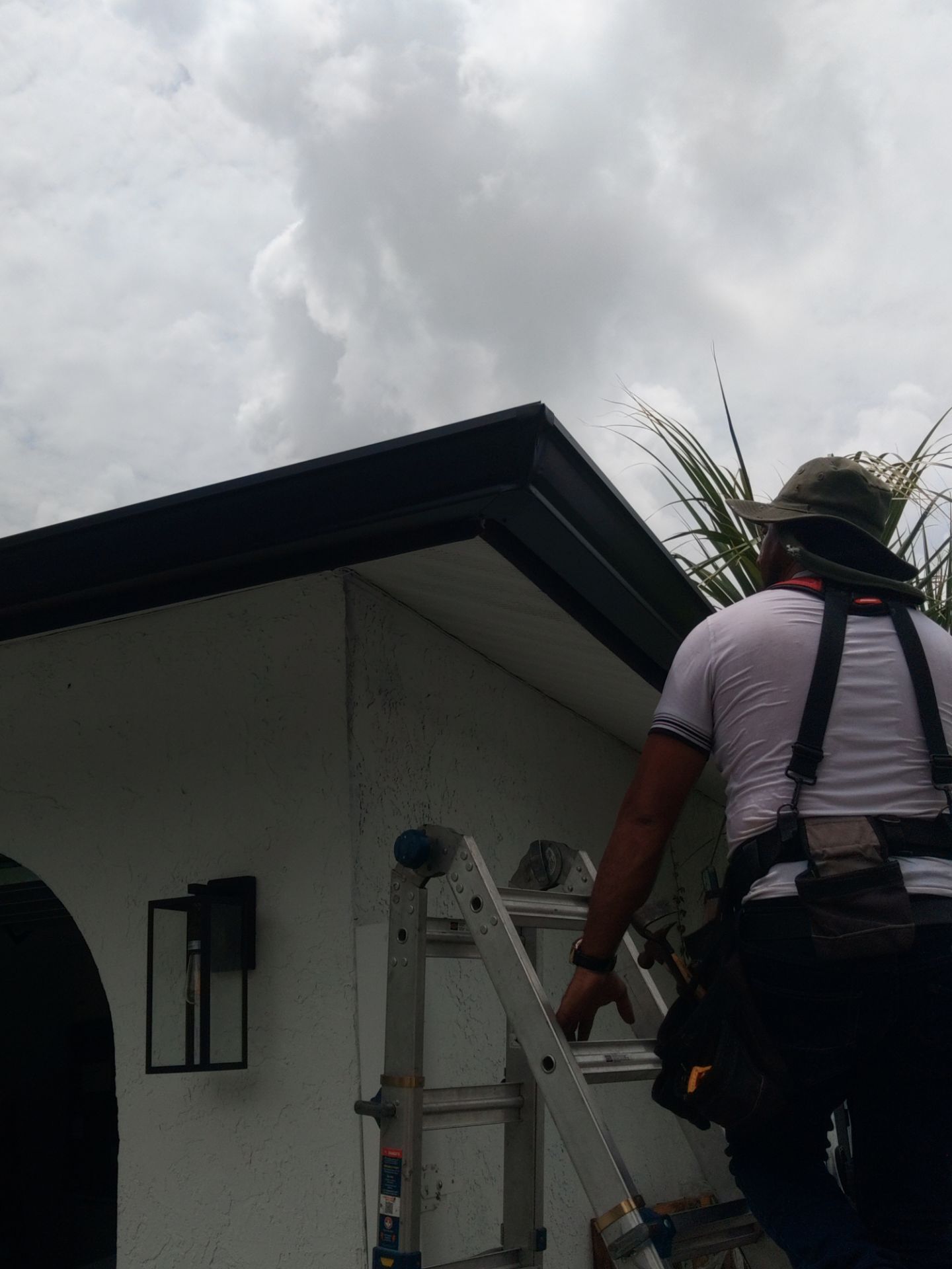 Black seamless gutters and downspouts installation in Sarasota, FL by Gutter Professors