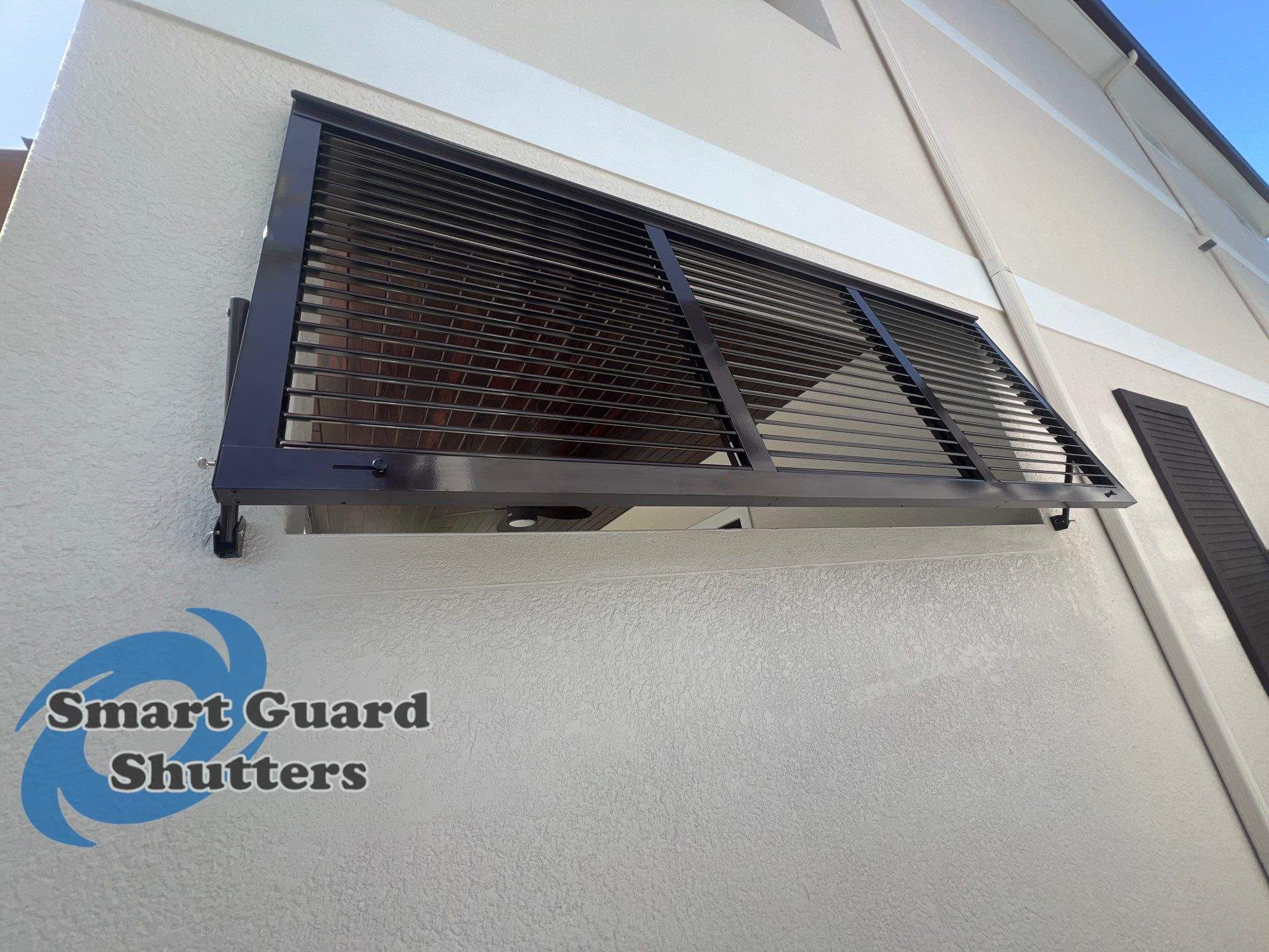 Impact Bahamas in Grey Brown  by Smart Guard Shutters