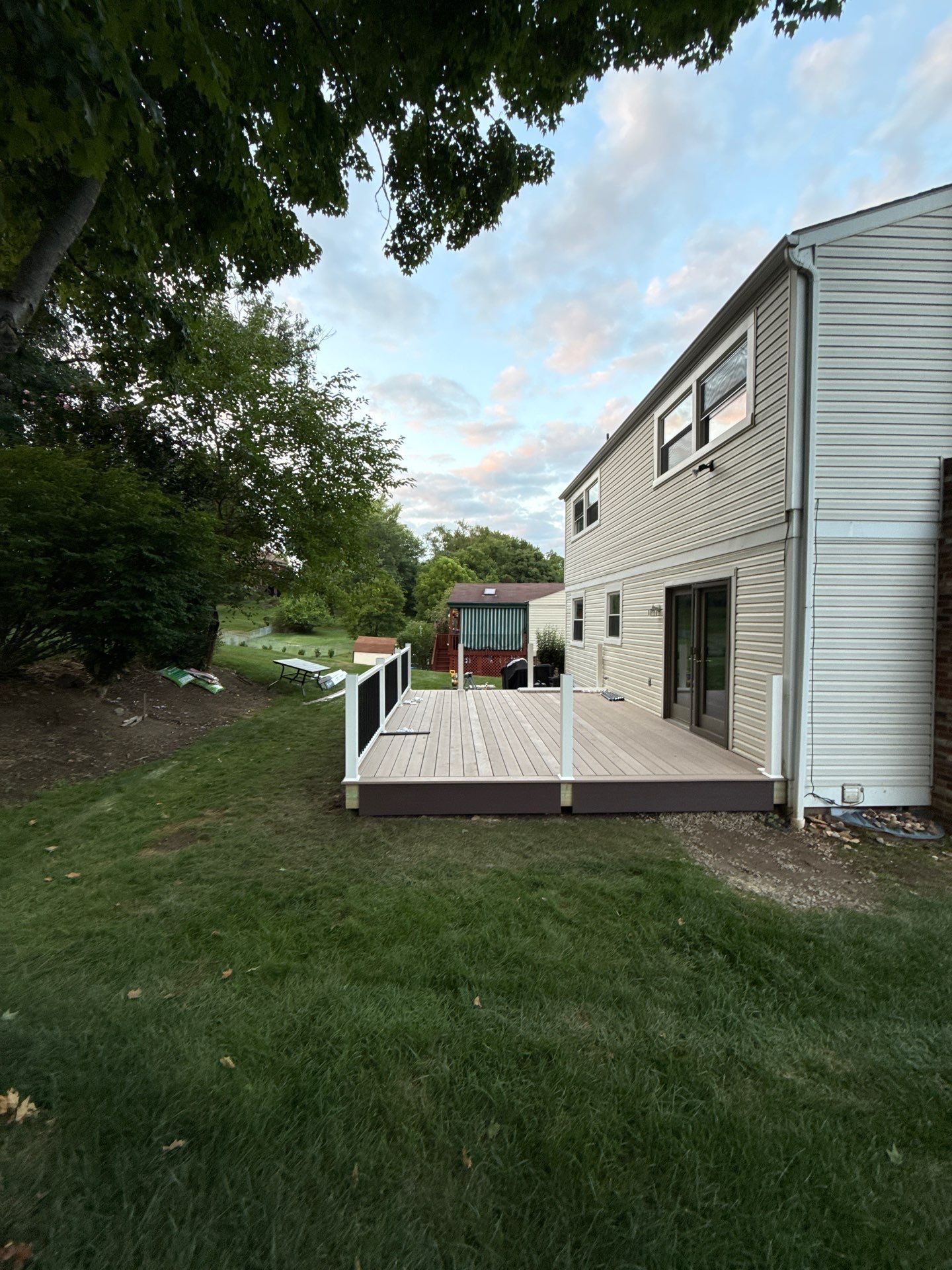 Bridgeville Composite Deck Build with White Railings and Versalok Retaining Wall by Cousins Roofing Siding & Decks