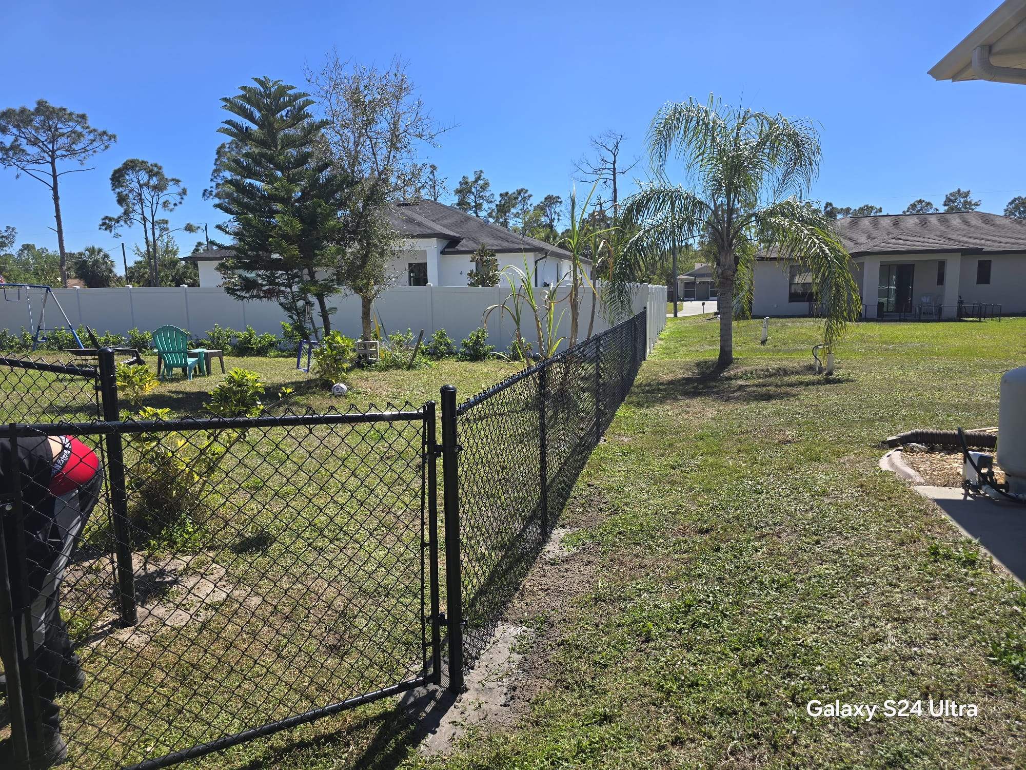 Residential Black Vinyl-Coated Chain Link Fence Installation in North Port by True Fence LLC