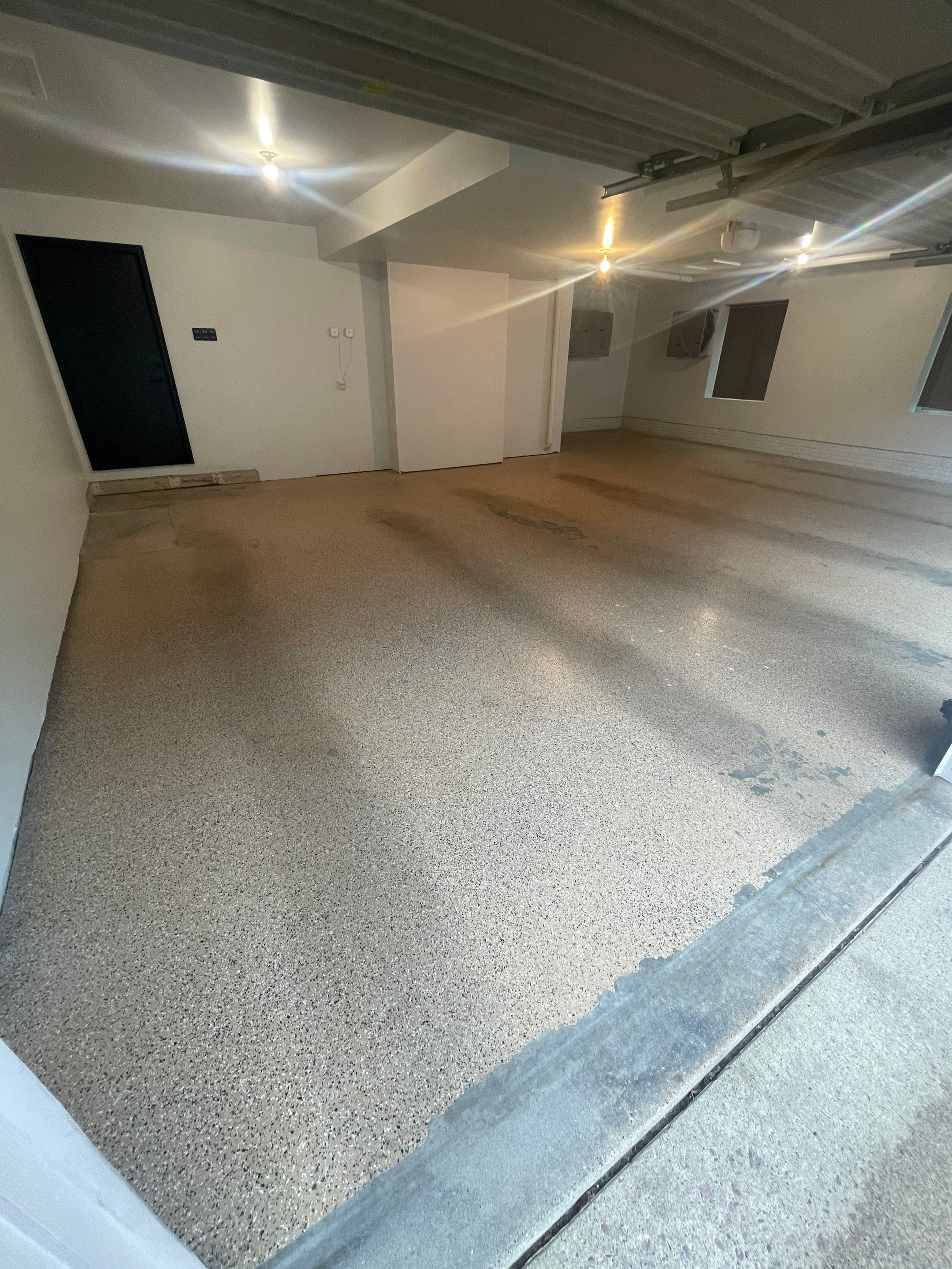 Gray Speckled Epoxy Garage Floor Coating in Sioux Falls by Select Painting, Coatings & Garage Cabinets