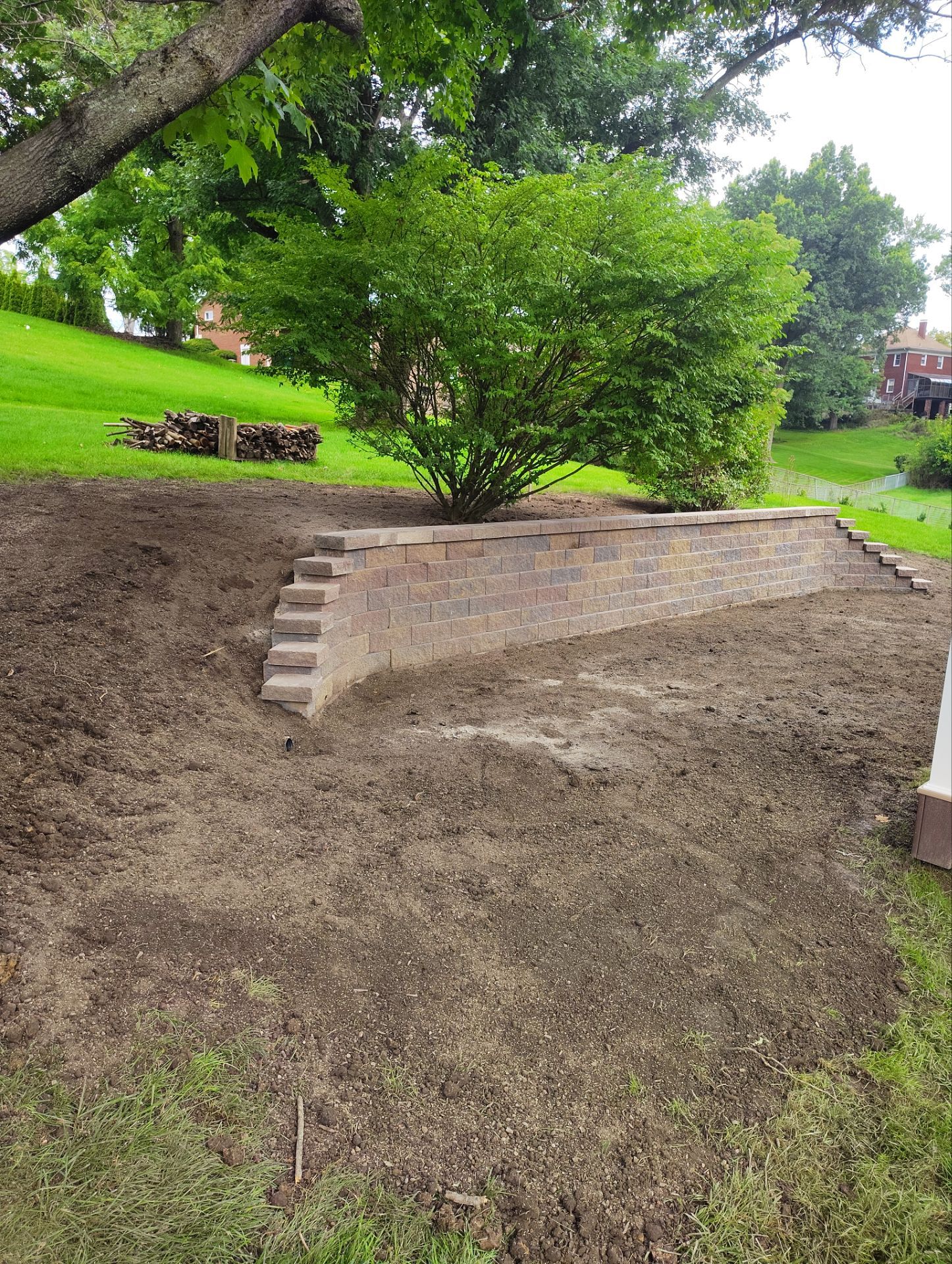 Bridgeville Composite Deck Build with White Railings and Versalok Retaining Wall by Cousins Roofing Siding & Decks
