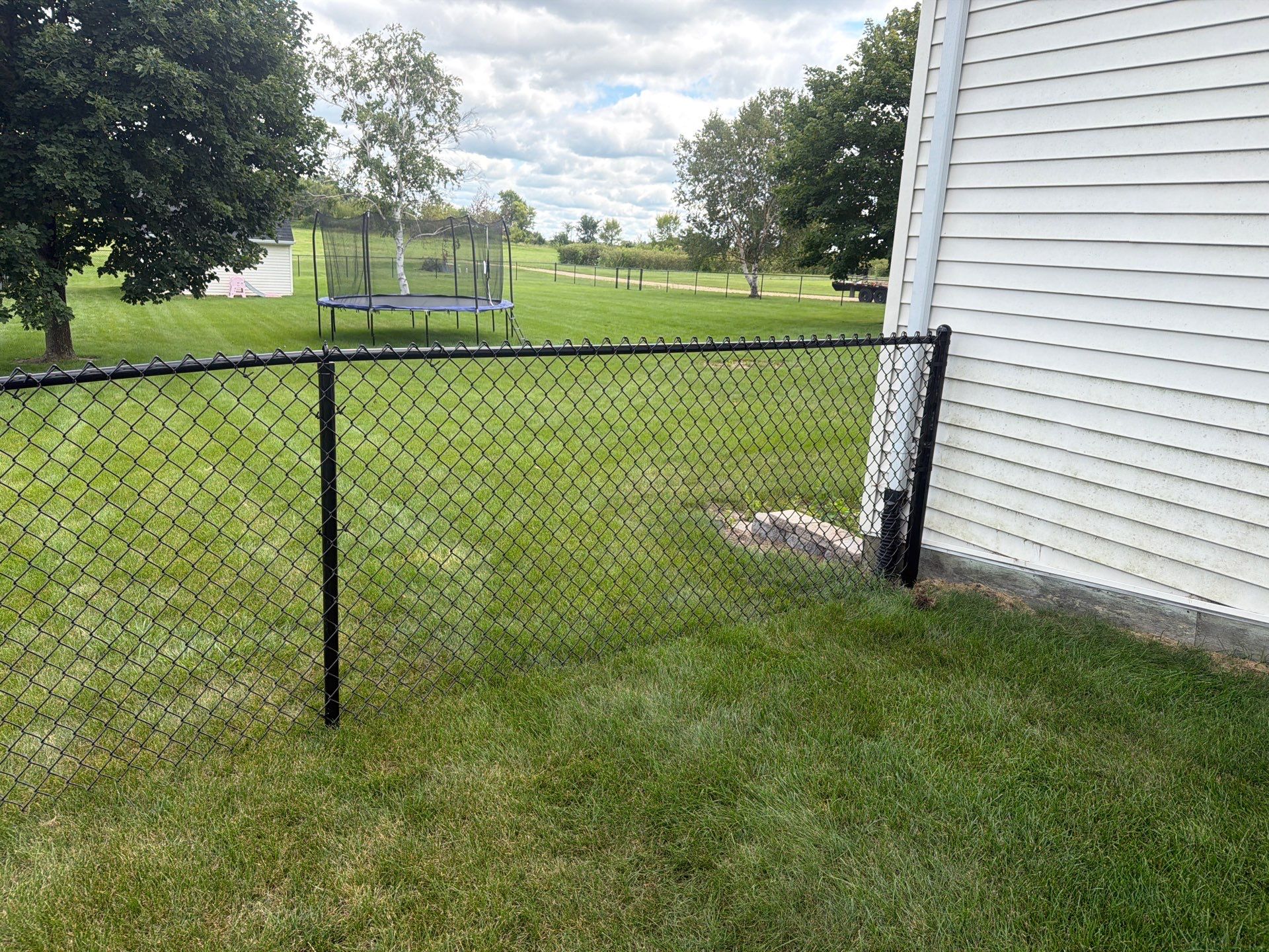 Black Vinyl-Coated Chain Link Fence Installation in Fairbank by Perfect Picket Fence and Stain