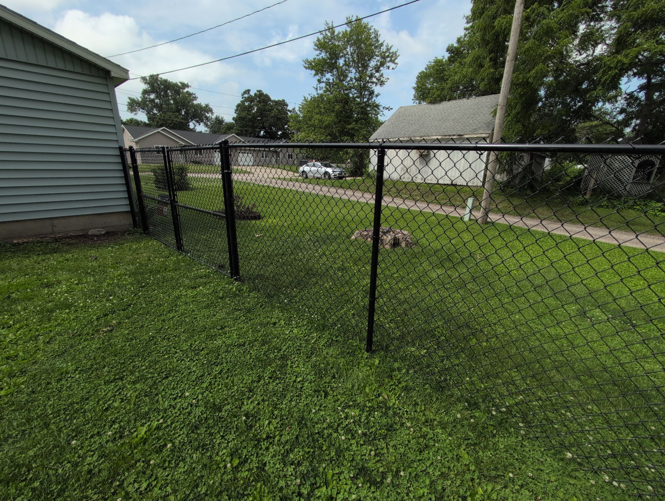Black Vinyl Coated Chain Link Fence Installation in Independence by Perfect Picket Fence and Stain