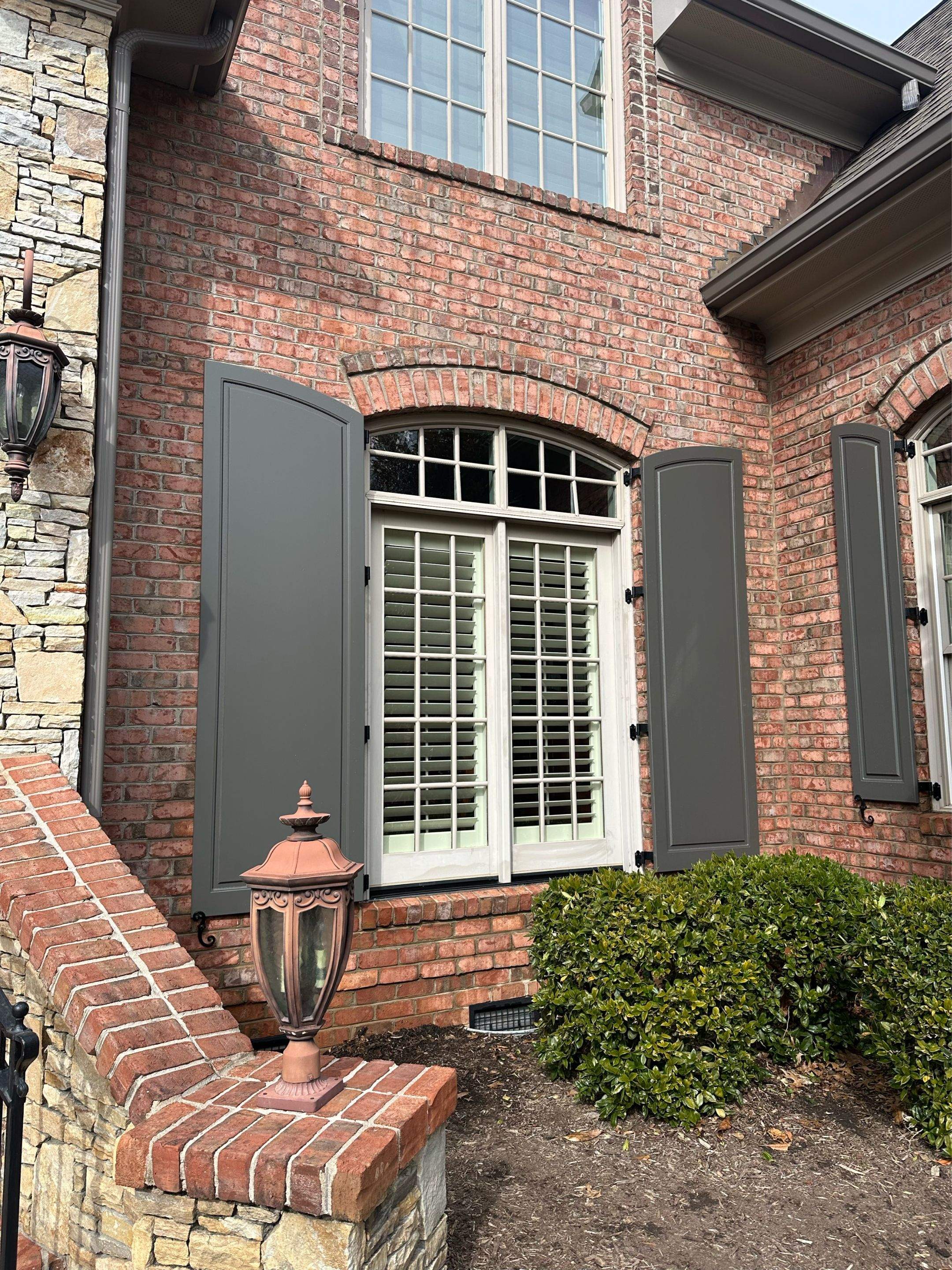 Exterior raised panel shutters by Southern Traditions Window Fashions