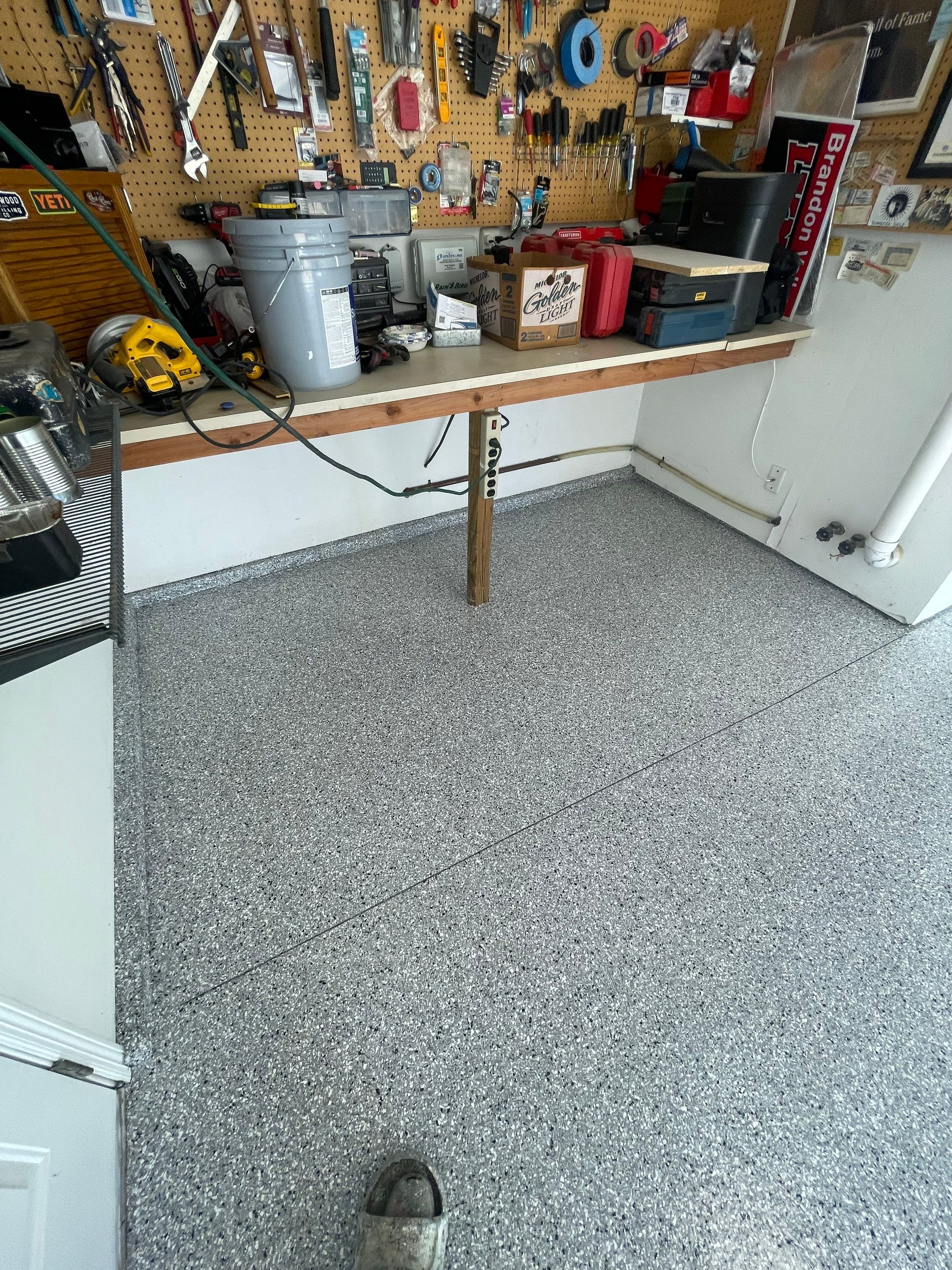 Feather Grey Garage Floor Coating Installation in Sioux Falls by Select Painting, Coatings & Garage Cabinets