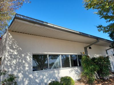 Completed metal roof on commercial building with landscaping