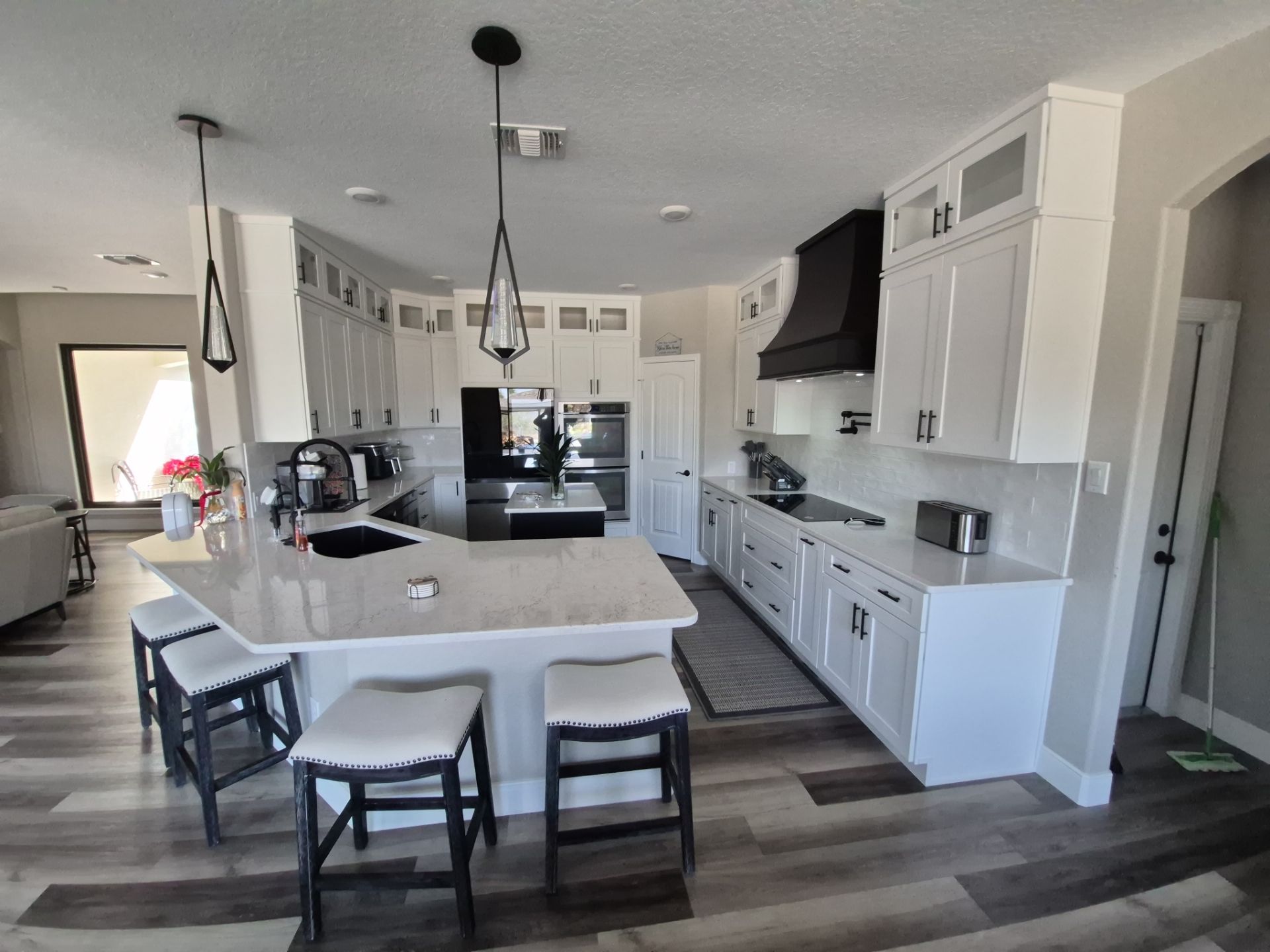 Modern White Kitchen Remodel in San Antonio Featuring Black Range Hood Before and After by Legacy Bath and Kitchen 