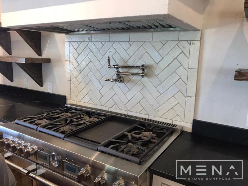 Kitchen, outdoor kitchen and pool brick floor installation by Mena stone surfaces