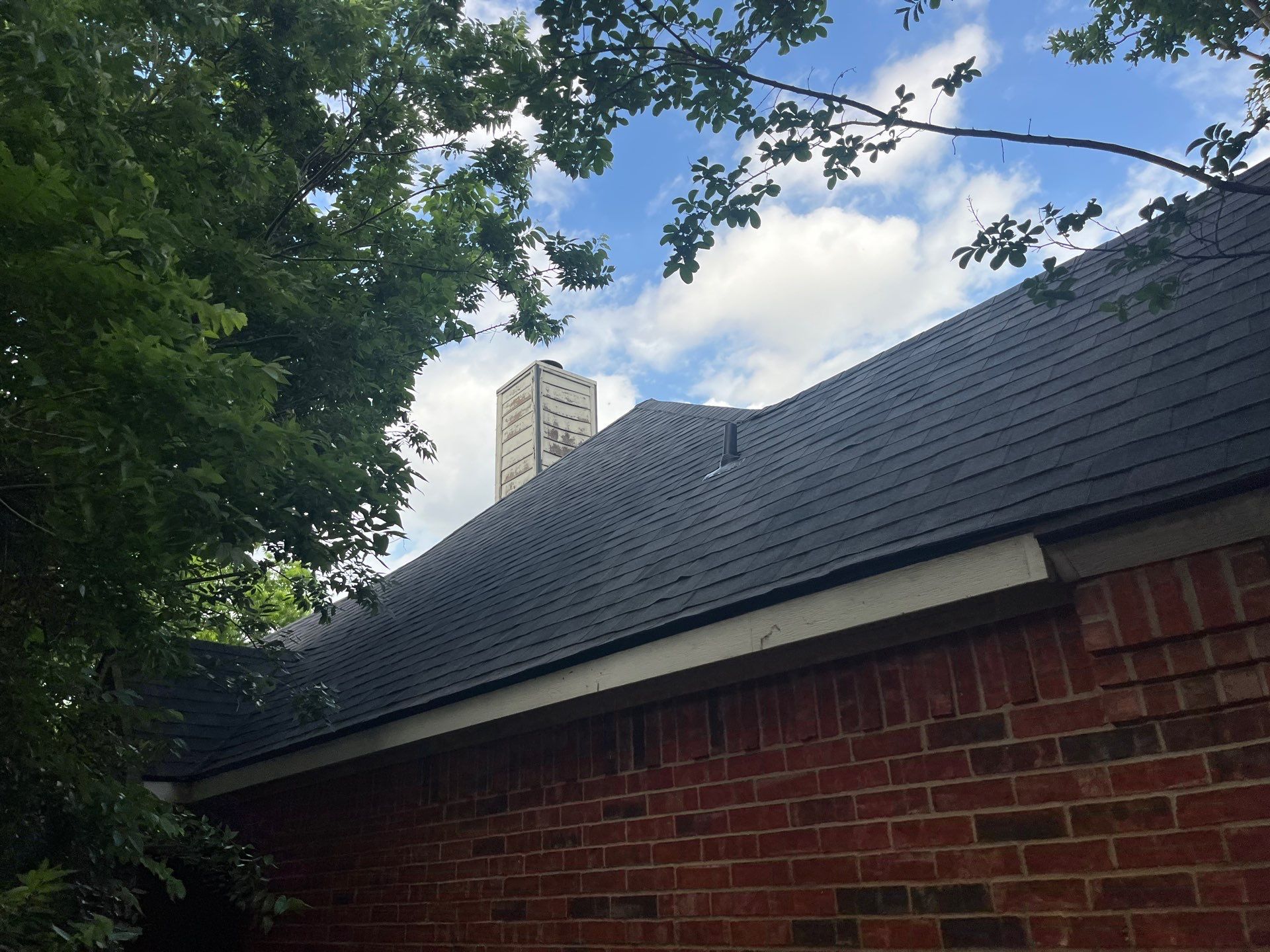Red brick with Malarkey Midnight Black  by Tejas Roofworks + Restoration