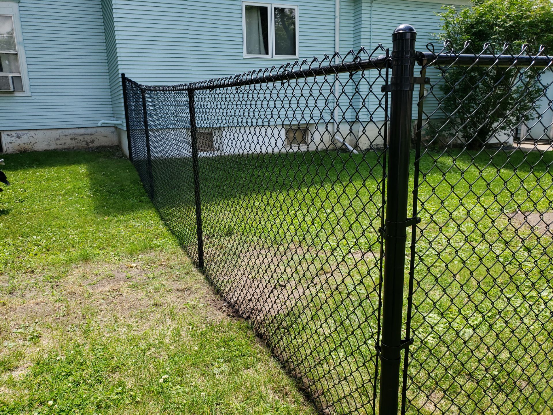 Black Vinyl Coated Chain Link Fence Installation in Independence by Perfect Picket Fence and Stain
