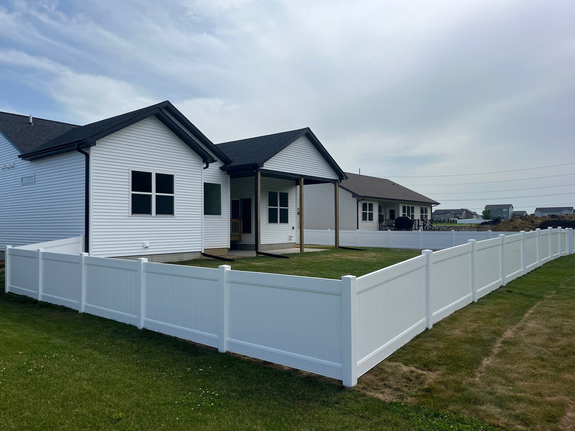 White Vinyl Privacy Fence With Pet Window in Cedar Falls by Perfect Picket Fence and Stain