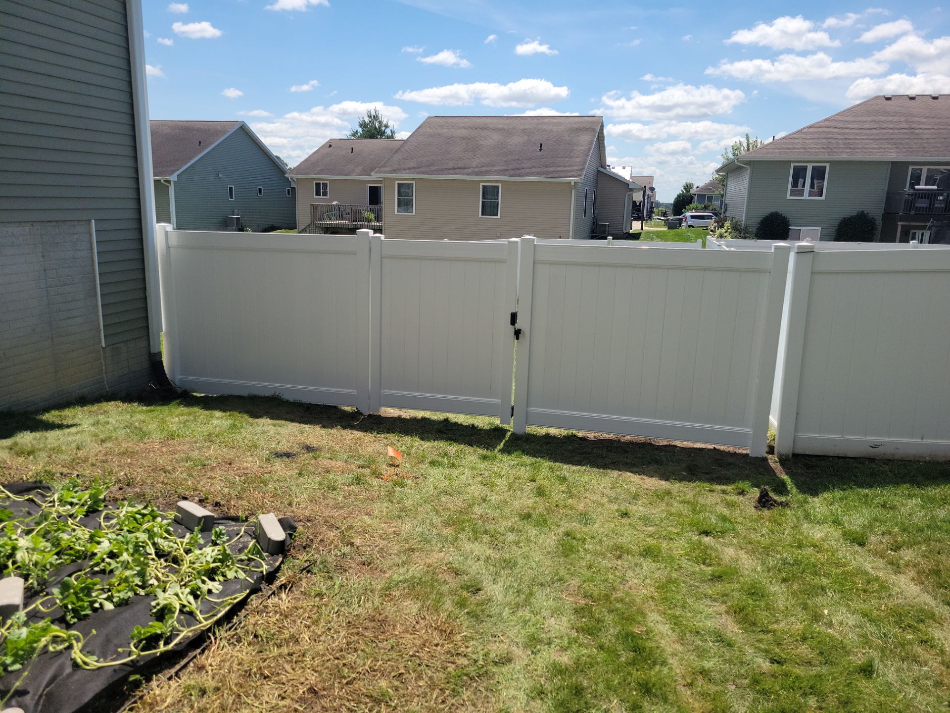 White Vinyl Privacy Fence and Ornamental Gate Installation in Janesville by Perfect Picket Fence and Stain