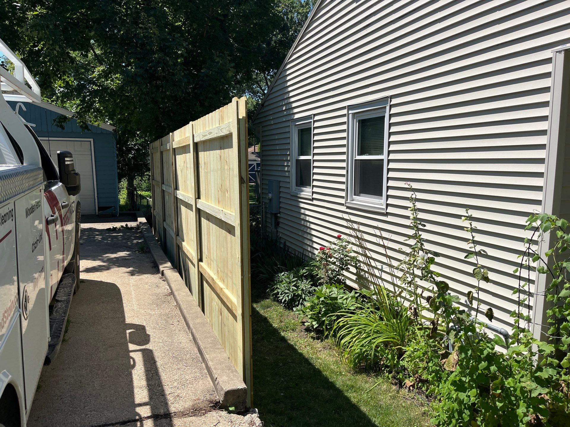 Pressure-Treated Wood Privacy Fence Installation in Cedar Falls by Perfect Picket Fence and Stain