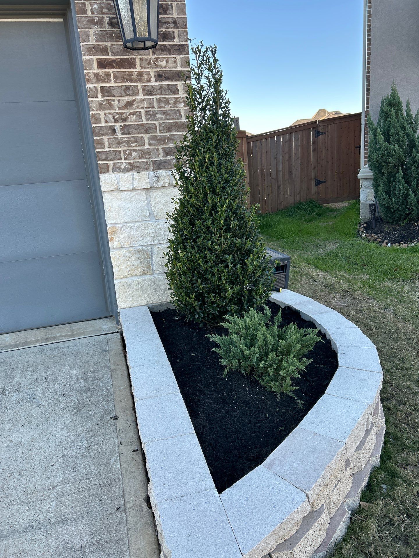 🌿✨ Darlene & Andrew’s Amazing Curb Appeal Transformation  Some projects are more than just landscaping—they’re a conversion of curb appeal from the ground up. For Darlene & Andrew, Alejandro and the Texas Urban Team designed and delivered a complete solution that reshaped their flower beds, solved drainage challenges, and gave new life to the sideyard.  💡 From planning to execution, every step was tailored to build both beauty and functionality:  🌸 Flower Beds, Reinvented  Demolition of old beds, plants, and mulch.  Fresh soil preparation, weed protection, and a brand-new retainer wall built with hand-cut stone and decorative caps.  Carefully selected plants and garden mix to ensure health and visual harmony.  💧 Drainage & Irrigation Upgrades  Outdated corrugated pipes replaced with PVC drainage lines to carry water safely away from the foundation.  New irrigation system combining drip lines and sprinklers—watering plants while keeping the house walls protected.  Sideyard drainage extended with catch basins and PVC piping to prevent water pooling and foundation stress.  🚶 Functional Sideyard with Walkway & Trash Area  Graded and leveled sideyard to manage runoff.  Installed a modern gravel and paver walkway for easy access.  Built a firm and tidy concrete-paver pad for trash containers—making the space both practical and polished.  🛠️ Stonework & Craftsmanship  Every stone in the retainer wall was cut, set, and secured by the team of handcrafters, ensuring a durable build that doubles as a design statement.  ✅ Outcome: Darlene & Andrew’s property now has better drainage, a clean and organized sideyard, and elegant new flower beds—all designed for long-term durability and lasting beauty.  📢 Before hiring anyone, review our portfolio. Our work speaks louder than words—each project is a blend of function, protection, and design crafted to last. by Texas Urban Elements