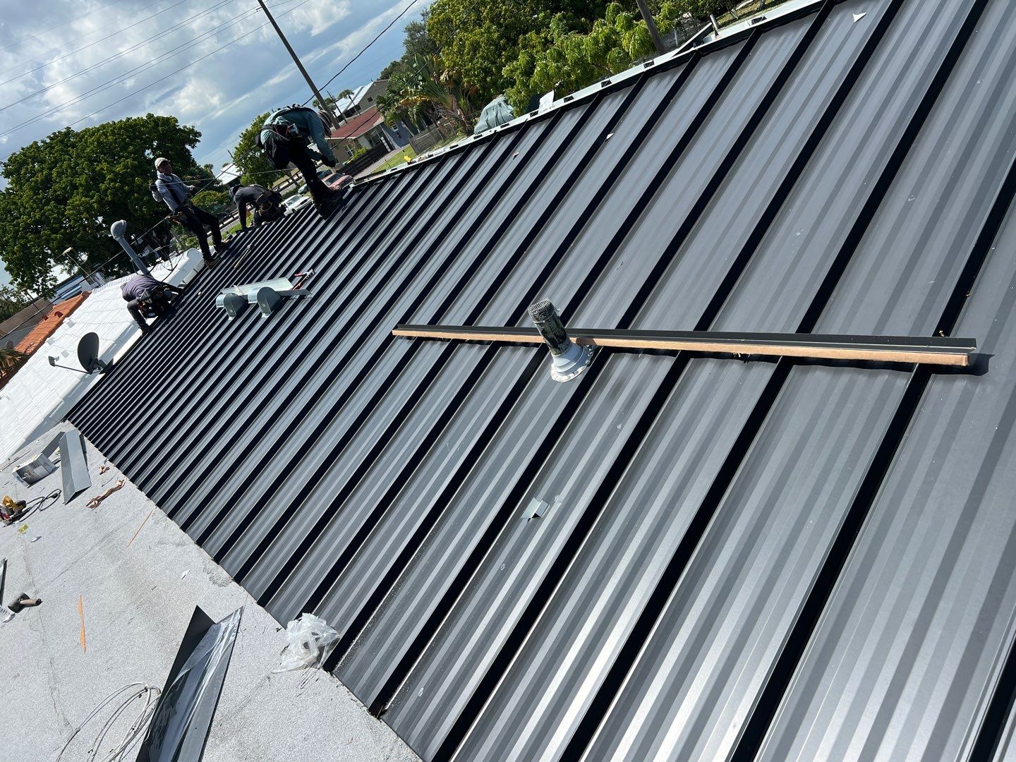 Standing Seam Metal & Flat Re-Roof using 1.5" Nail Strip 24ga Black Matte Kynar Coated Standing Seam Metal Panels by Morton Roofing, Inc.