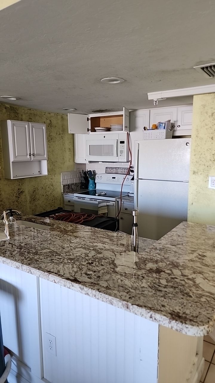 Damage caused from leaking water hea  er by Building performance Solutions LLC
