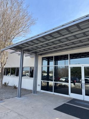 Completed metal roof structure on commercial building entrance