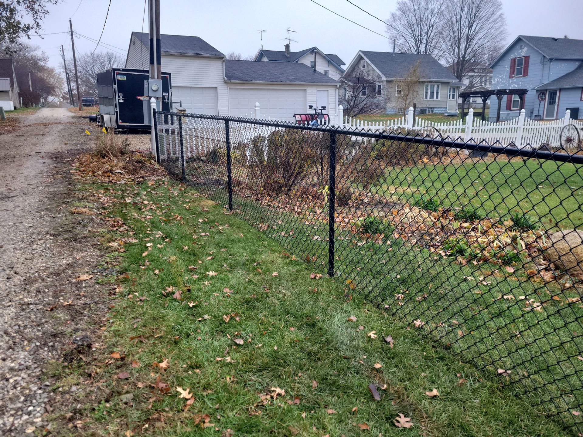Black Vinyl-Coated Chain Link Fence Installation in Aplington by Perfect Picket Fence and Stain