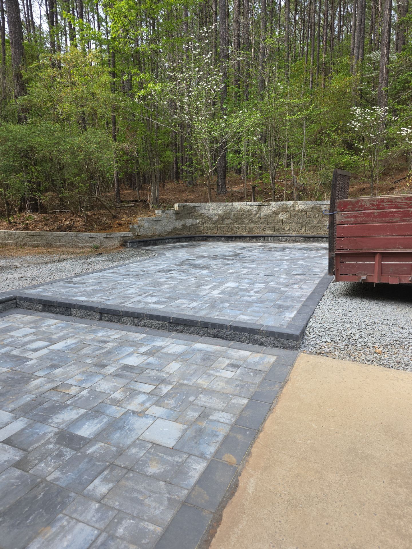 Pittsboro Outdoor Living Transformation – Retaining Wall, Paver Patio & Elevated Deck by Elite Remodeling and Design LLC