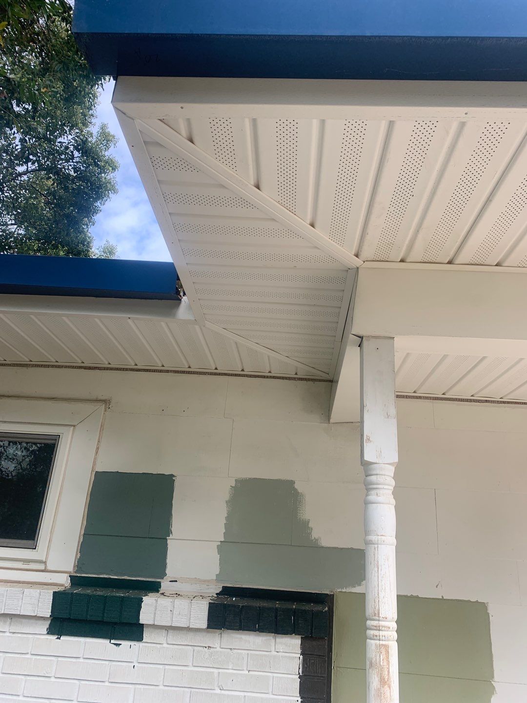 White Seamless Gutters and Black Downspouts by Gutter Professors