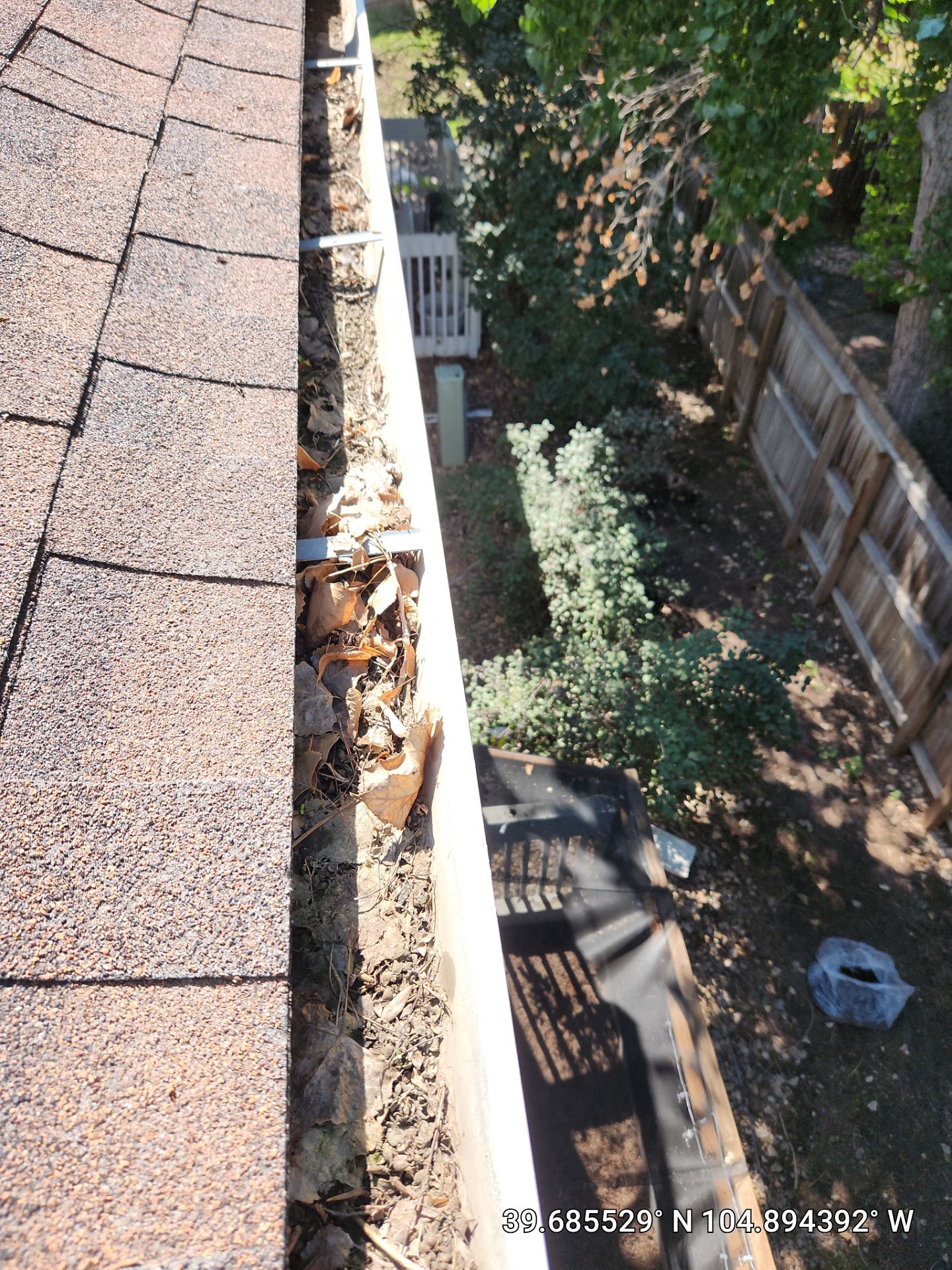Commercial gutter cleaning Denver, CO before photo with filled gutters