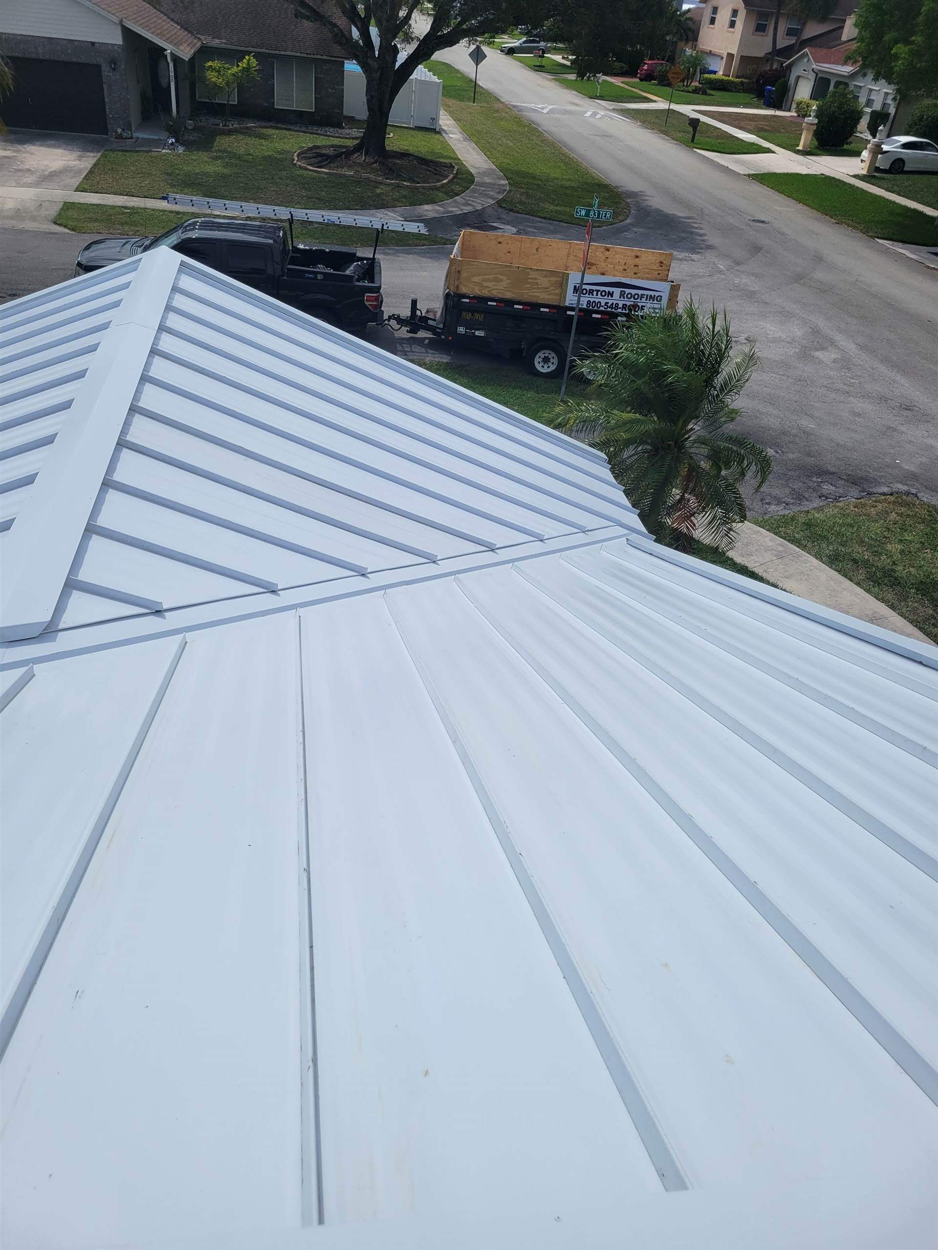 Standing Seam Metal & Flat Re-Roof using 1.5" Nail Strip 24ga Solar White Kynar Coated Standing Seam Metal Panels by Morton Roofing, Inc.