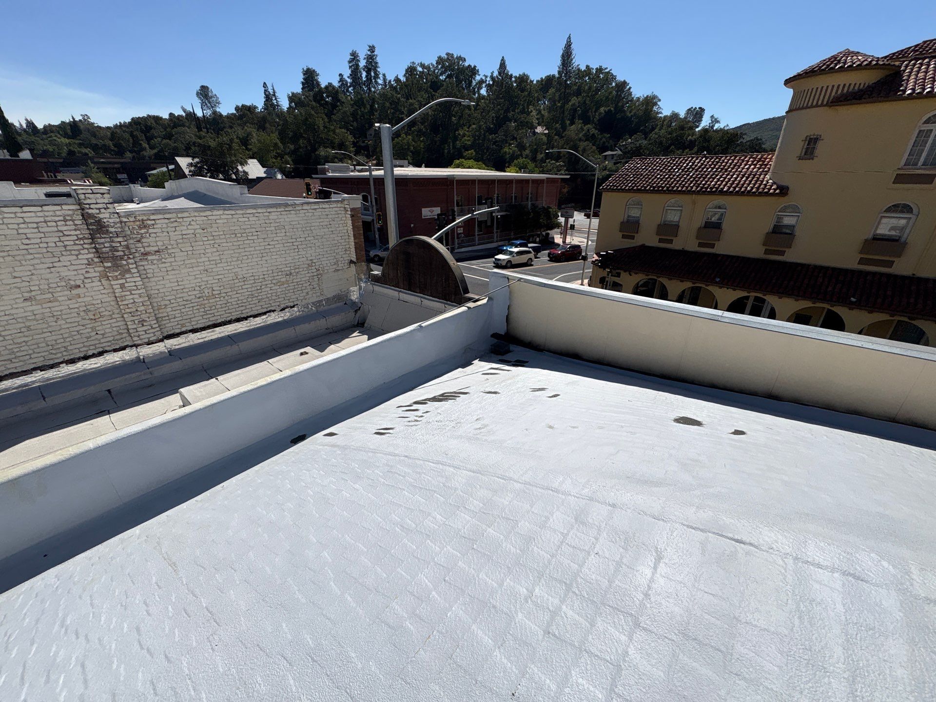 Foam and coatings on commercial roof by Straight Edge Roofing Inc