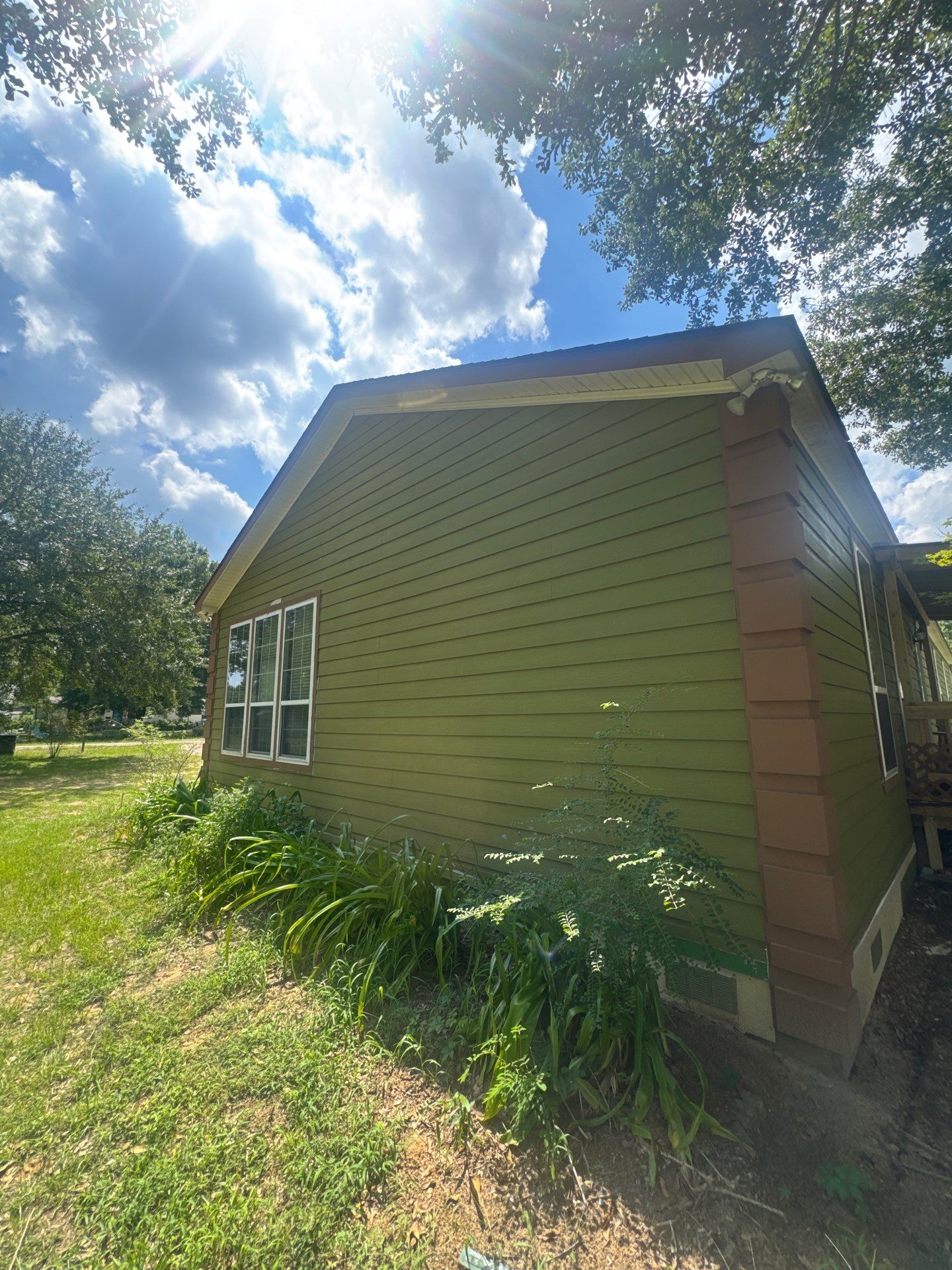 Exterior Painting in Lindale, TX | Bright Green Wood House Repaint by Quality Coats Painting